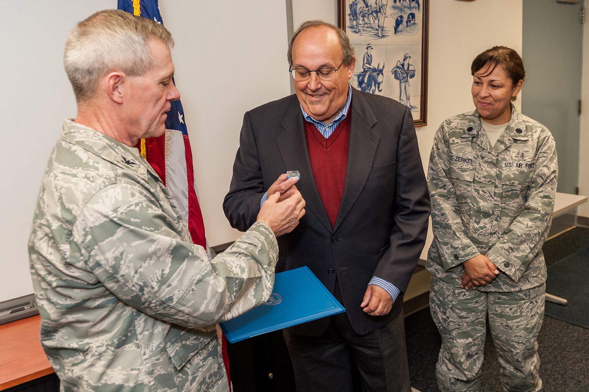 Col. Lorn Heyne (left) 65th Medical Group commander and Lt. Col. Zoya Lee-Zurkel, 65th Medical Support Squadron commander present Francisco Toste with a pin and certificate for 40 years of civil service with the U.S. Air Force, Nov. 12, 2012, Lajes Field.  Toste, a native of Terceira, started his service on Oct. 13, 1972 as a billeting clerk.  He worked there for nine years before moving over to the civil engineer squadron and working at the service call desk, then as a translator, on to drafting and ended in the surveying department.  In 1989, Toste moved to the medical group and has worked as a facility manager since then.  (Photo by Lucas Silva)