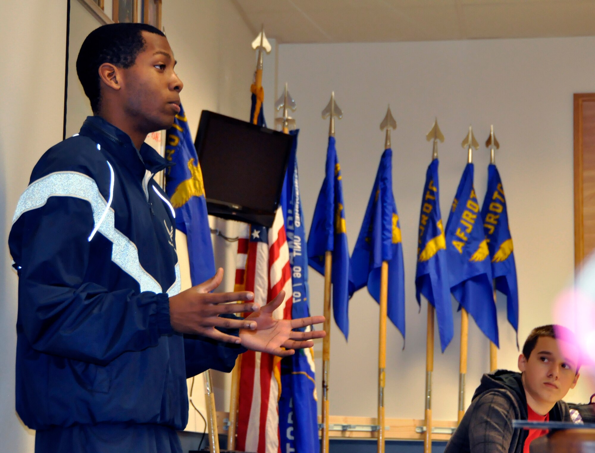 Trainee Anthony Hogan, a future crew chief with the 446th Airlift Wing at McChord Field, explains service physical fitness standards to a class of Air Force Junior Reserve Officers' Training Corps cadets at Todd Beamer High School in Federal Way, Wash. Hogan regularly visits the high school as an alumni to mentor his former JROTC teammates. He has been a part of the wing's Development and Training Flight since August of 2012. (U.S. Air Force Photo/Staff Sgt. Rachael Garneau)