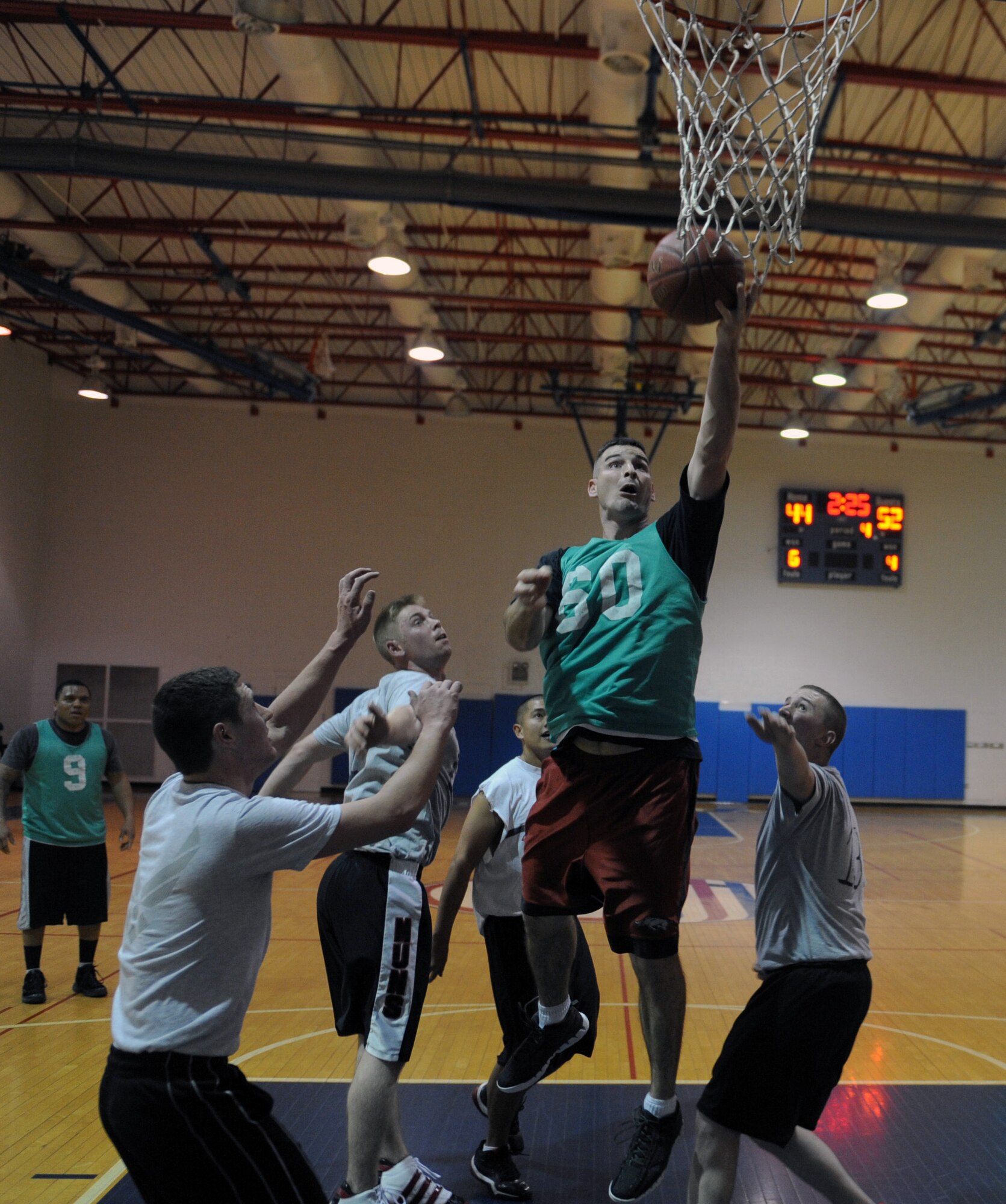A member of the 509th Operations Support Squadron basketball team drives to the hoop for a layup against the 23rd Fighter Group at the Fitness Center, Nov. 27 at Whiteman Air Force Base, Mo. The 509th OSS won the game 60-49. (U.S. Air Force photo/Airman 1st Class Bryan Crane) (Released)