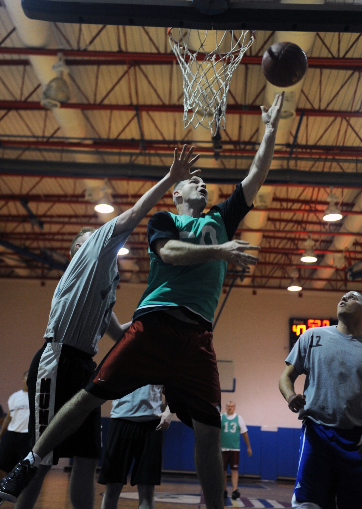 A member of the 509th Operations Support Squadron basketball team drives to the hoop for a layup against the 23rd Fighter Group at the Fitness Center, Nov. 27, at Whiteman Air Force Base, Mo. OSS defeated the 23rd FG 60-49. (U.S. Air Force photo/Airman 1st Class Bryan Crane) (Released)