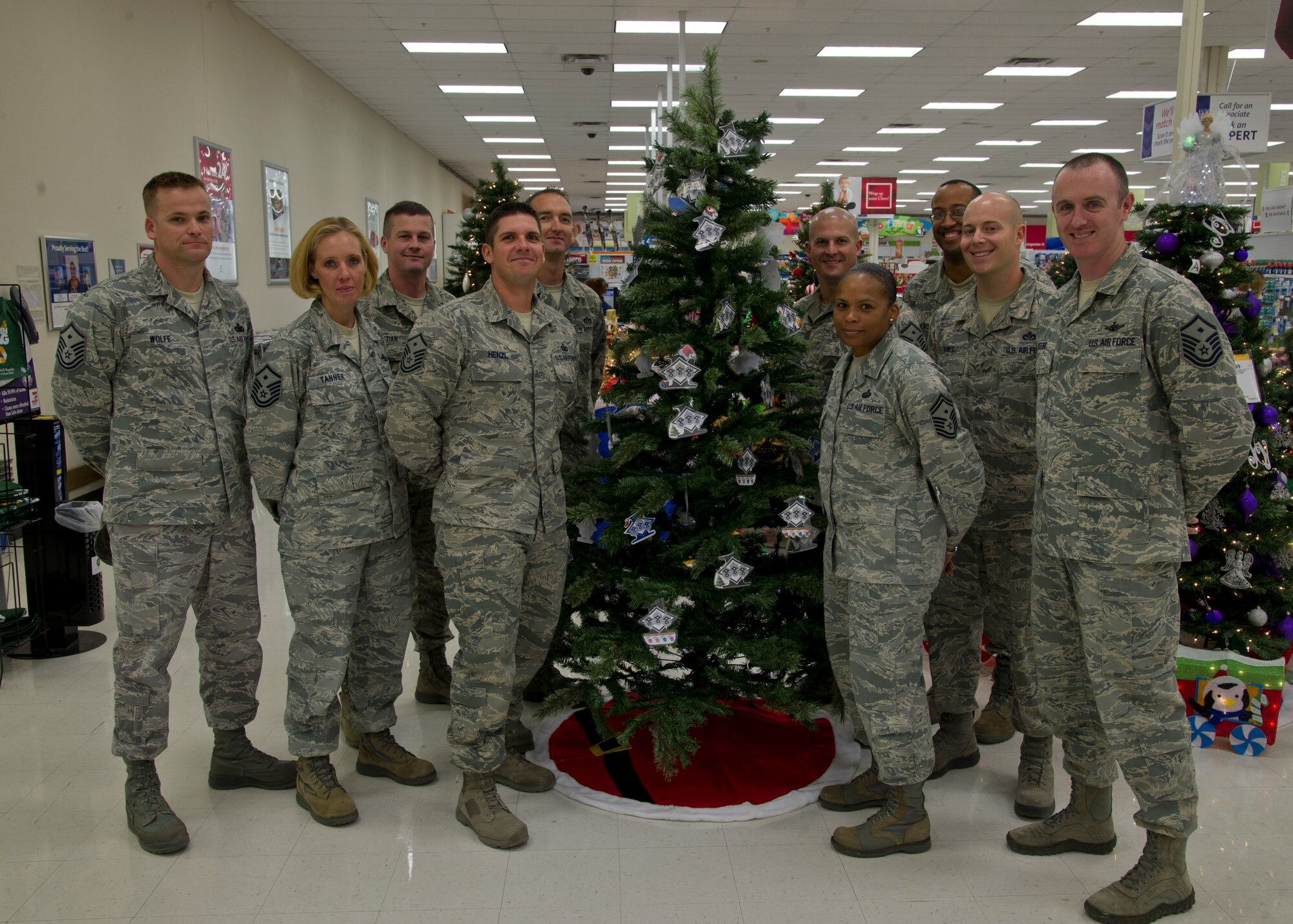 Members of the Holloman Air Force Base, N.M., First Sergeant’s Council pose around the Diamond Tree Nov. 21 at The Exchange. The Diamond Tree, sponsored by the Holloman AFB First Sergeant’s Council, contains more than 100 ornaments that provide the name of a child, clothing size, and gift idea for those who would like to help children of military families who are struggling financially. In addition to the tree that was placed in The Exchange, there is also a tree in the Soaring Heights Welcome Center. (U.S. Air Force photo by Senior Airman DeAndre Curtiss/Released)

