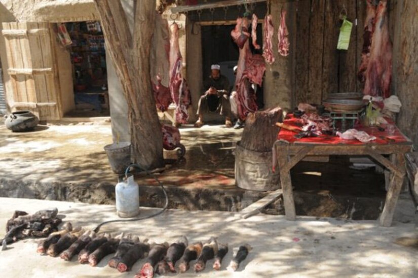 An Afghan butcher waits for customers at his storefront in Ghazni province, Afghanistan, 2009. (U.S. Air Force photo/Master Sgt. Rebecca Corey)