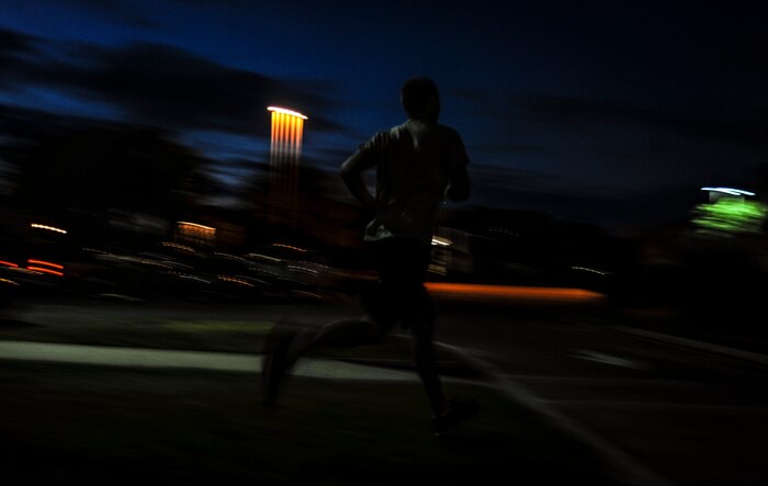 A CrossFit participant runs out the side of the gym after completing power cleans and kipping pull-ups during a CrossFit class Nov. 19, 2012, at the Joint Base Charleston – Air Base gymnasium. CrossFit uses random physical challenges so each workout is varied and high in intensity. (U.S. Air Force photo/ Senior Airman Dennis Sloan)