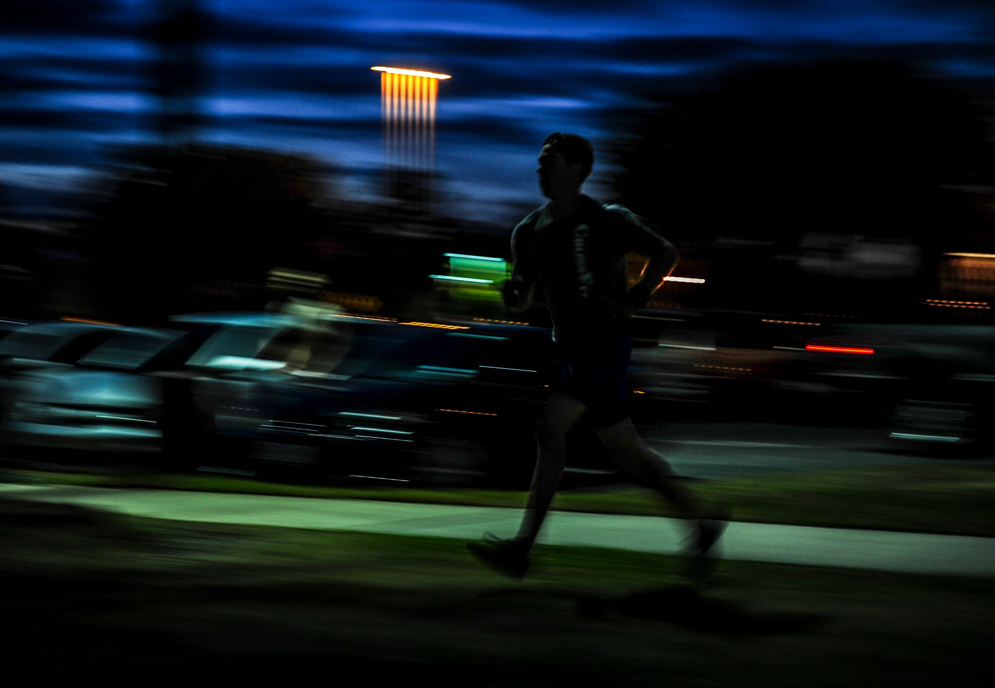 Lt. j.g. John Campion, Naval Nuclear Power Training Command student, runs back to the gym after completing a 400-meter sprint during a CrossFit class Nov. 19, 2012, at the Joint Base Charleston – Air Base gymnasium. CrossFit uses random physical challenges so each workout is varied and high in intensity. (U.S. Air Force photo/ Senior Airman Dennis Sloan)