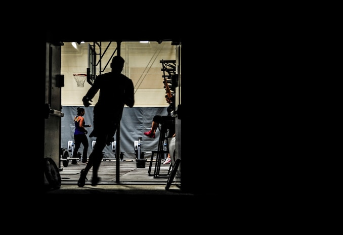 A CrossFit participant runs out the side of the gym after having completed power cleans and kipping pull-ups during a CrossFit class Nov. 19, 2012, at the Joint Base Charleston – Air Base Fitness Center. CrossFit uses random physical challenges so each workout is varied and high in intensity. (U.S. Air Force photo/ Senior Airman Dennis Sloan)