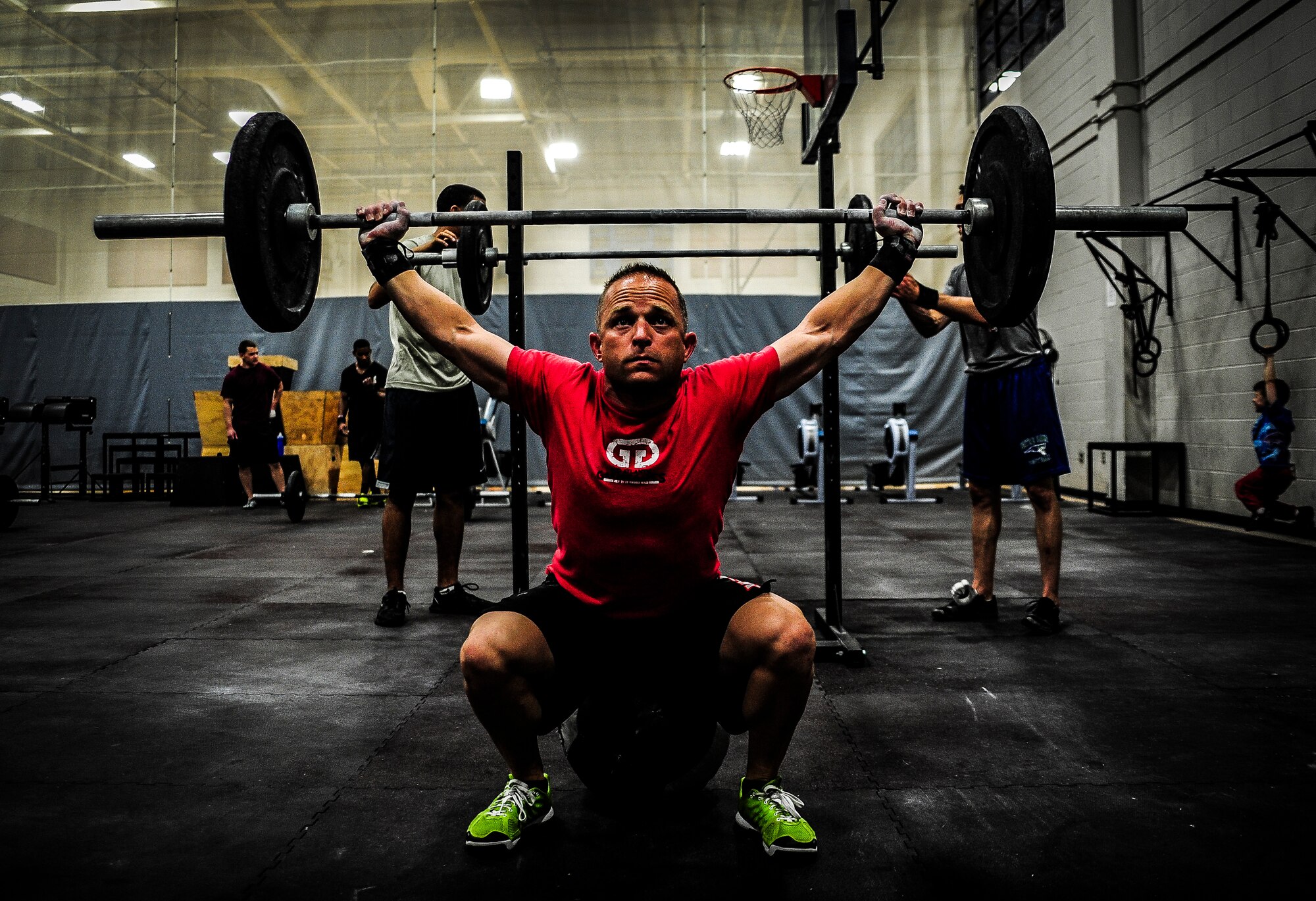 Chief Master Sgt. John Storms, 628th Security Forces Squadron superintendent, performs a power clean during a CrossFit class Nov. 19, 2012, at the Joint Base Charleston – Air Base Fitness Center. The CrossFit classes can accommodate individuals with different strength abilities and experience and there is always someone on hand to assist with proper form and technique. (U.S. Air Force photo/ Senior Airman Dennis Sloan)