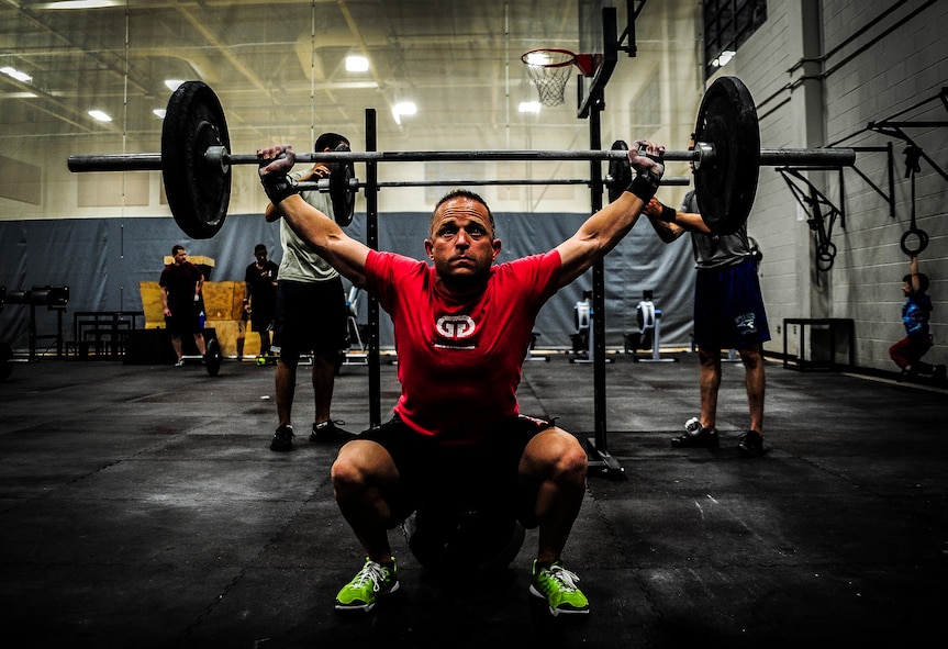 Chief Master Sgt. John Storms, 628th Security Forces Squadron superintendent, performs a power clean during a CrossFit class Nov. 19, 2012, at the Joint Base Charleston, S.C., Fitness Center. The CrossFit classes can accommodate individuals with different strength abilities and experience and there is always someone on hand to assist with proper form and technique. (U.S. Air Force photo/ Senior Airman Dennis Sloan)