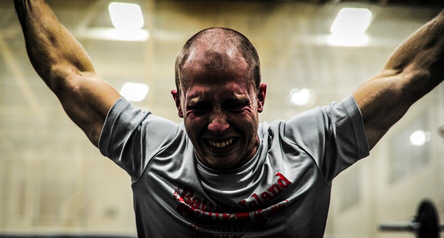 Senior Airman Joseph Schlank, 437th Aerial Port Squadron passenger terminal attendant, grimaces while performing a power clean during a CrossFit class Nov. 19, 2012, at the Joint Base Charleston, S.C., Fitness Center. The CrossFit classes can accommodate individuals with different strength abilities and experience and there is always someone on hand to assist with proper form and technique. (U.S. Air Force photo/ Senior Airman Dennis Sloan)