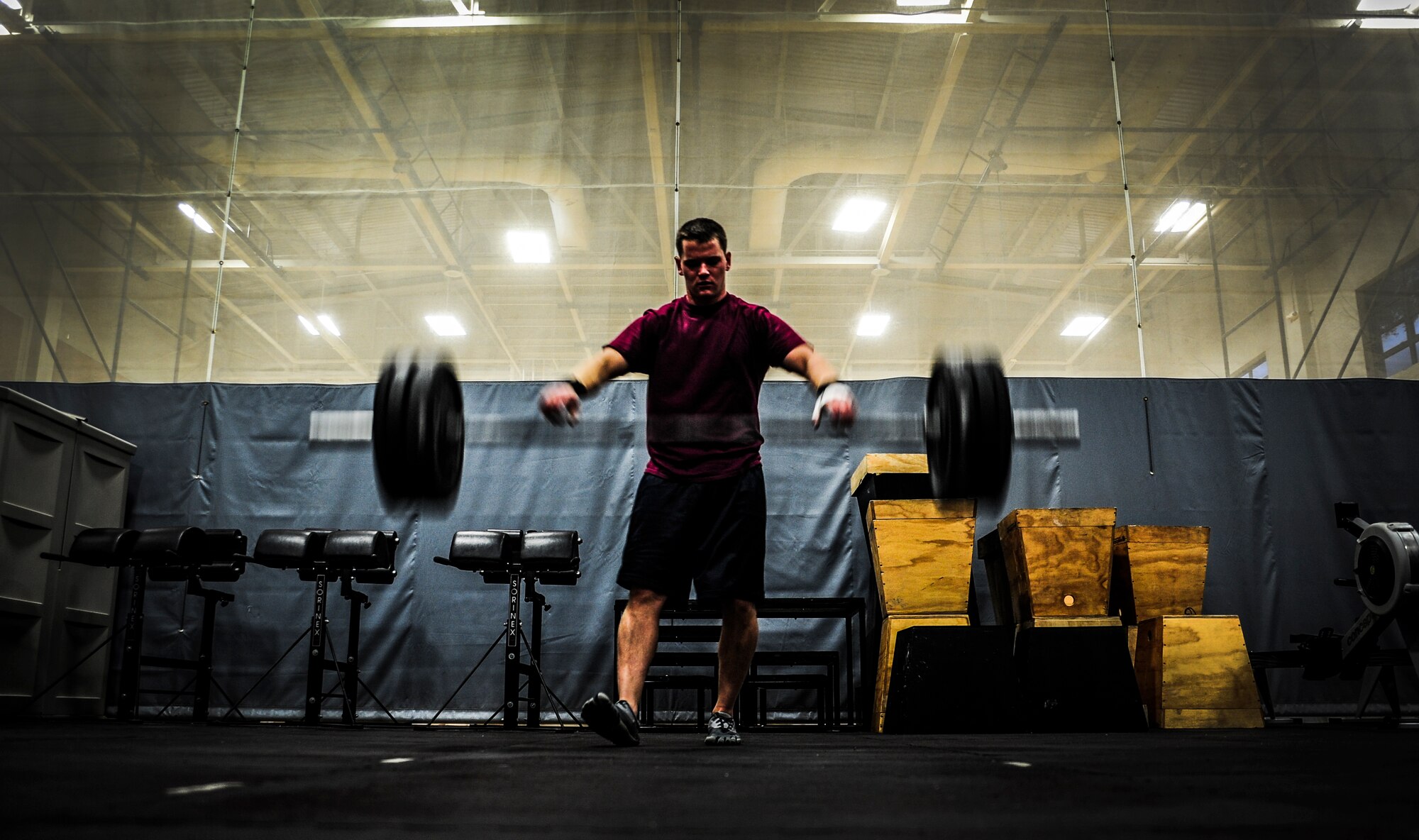 Airman 1st Class Andy Sims, 437th Maintenance Squadron crew chief, releases the bar and weights after performing a power clean during a CrossFit class Nov. 19, 2012, at the Joint Base Charleston – Air Base Fitness Center. The CrossFit classes can accommodate individuals with different strength abilities and experience and there is always someone on hand to assist with proper form and technique. (U.S. Air Force photo/ Senior Airman Dennis Sloan)