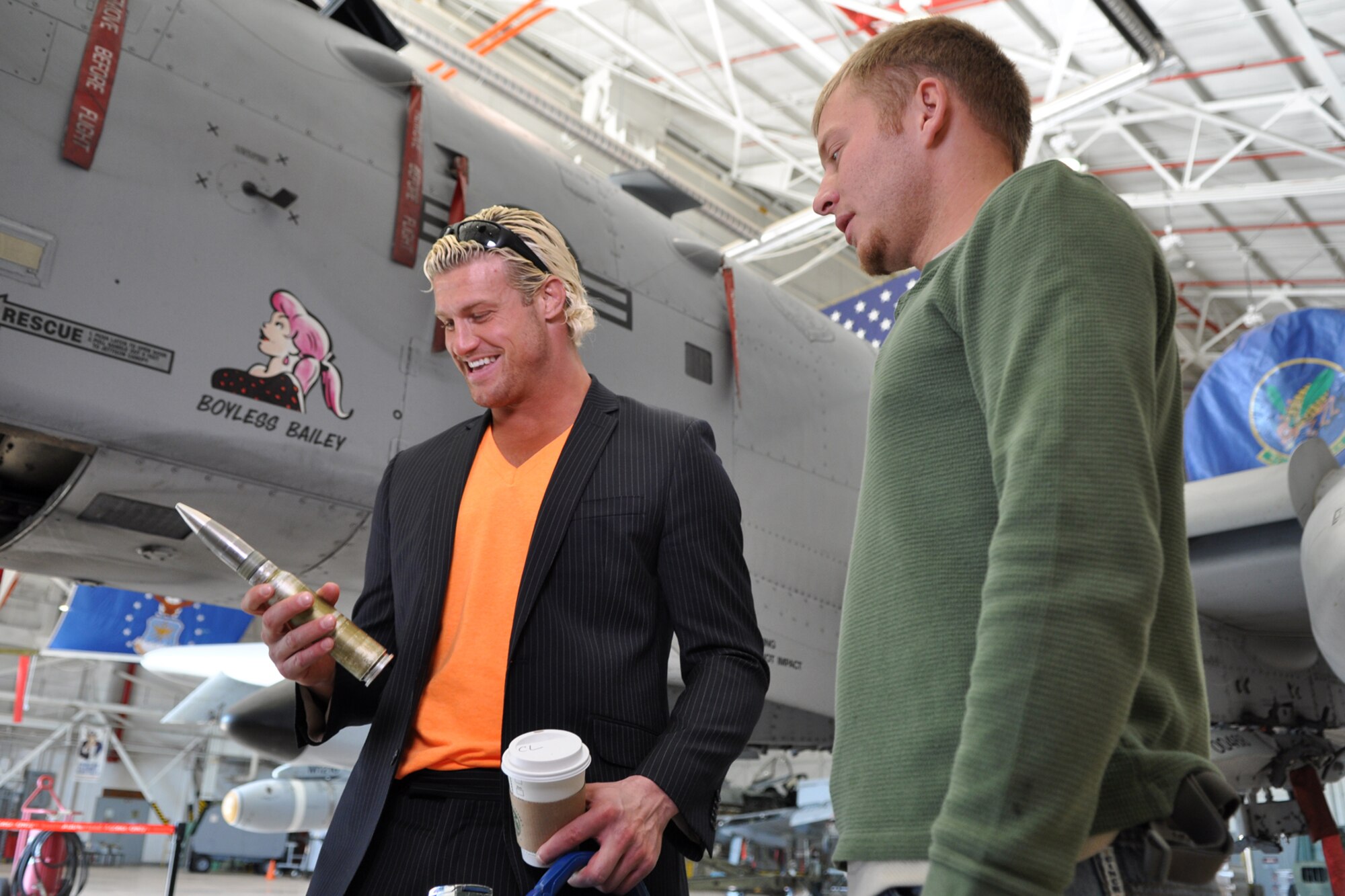 WWE’s Smackdown Superstar Dolph Ziggler, checks out a 30mm round during a briefing on the capabilities of the A-10 Thunderbolt II by Staff Sgt. John Slade during a visit to Barksdale Air Force Base, La., Nov. 27, 2012. WWE brought Smackdown to the CenturyLink Center in Bossier City, La., Nov. 27, and Ziggler asked to come to Barksdale to meet with the “troops.” Military members were invited to see the event free of charge. Slade is a dedicated crew chief assigned to the 917th Fighter Group. (U.S. Air Force photo by Master Sgt. Jeff Walston)