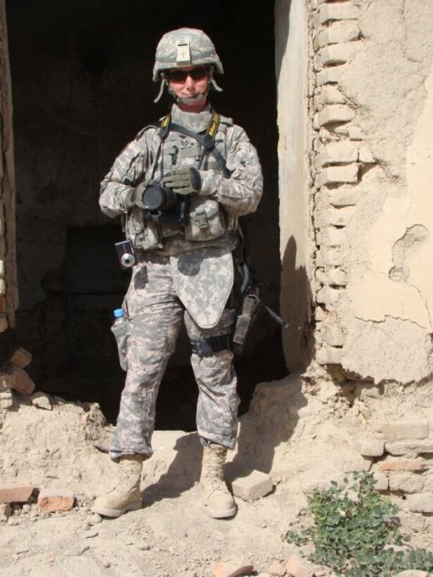 Then-Tech. Sgt. Rebecca Corey smiles for a rare photo of herself in the streets of Afghanistan during her deployement in 2009. Corey's mission was to document the efforts of the provinial reconstruction teams, working in the region. (U.S. Air Force photo)
