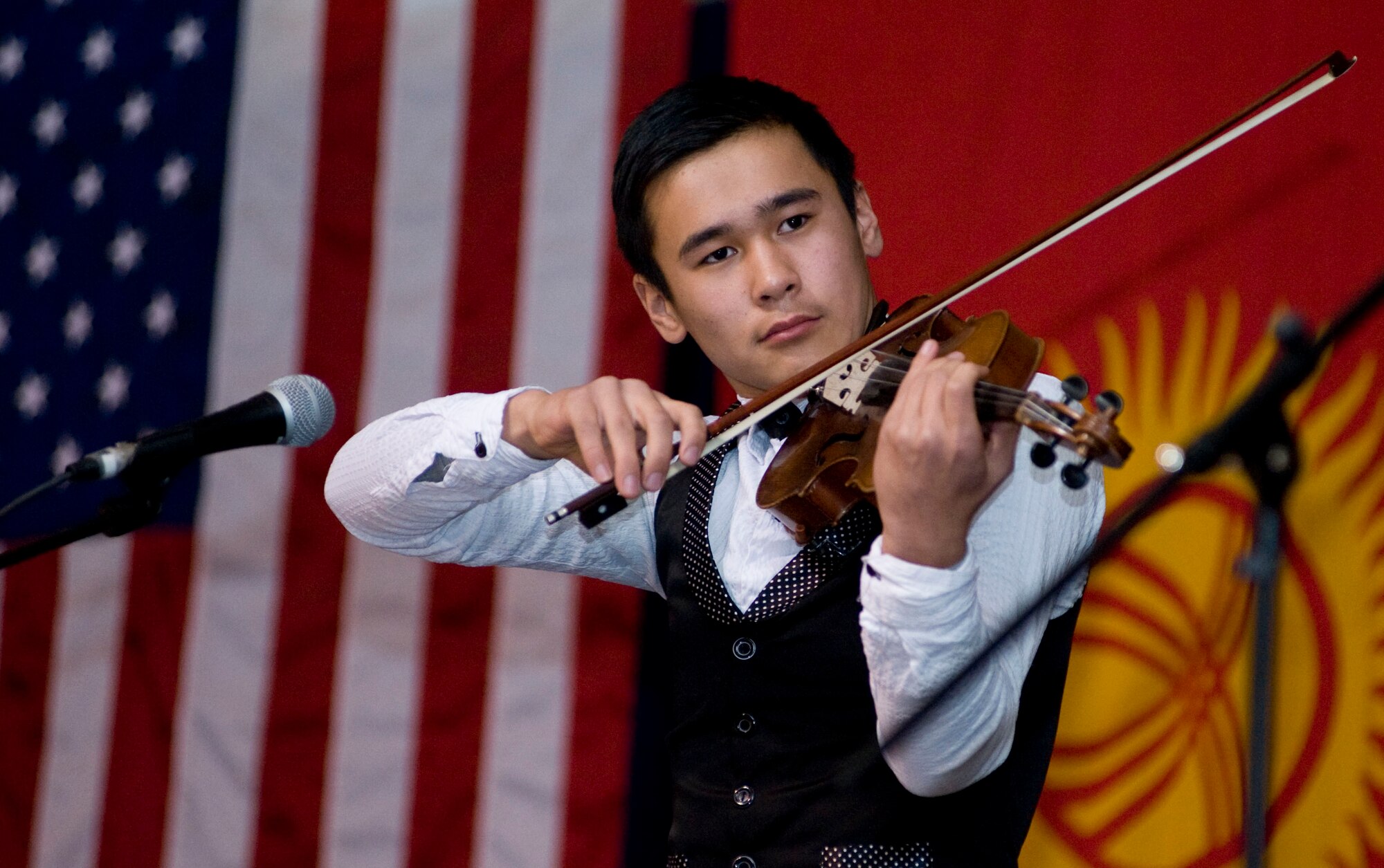 Arsen Abdrasul, 14, performs during a concert at the Transit Center at Manas, Kyrgyzstan, Nov. 27, 2012. Abdrasul is a student at the Mukash Abdraev National School of Music. 