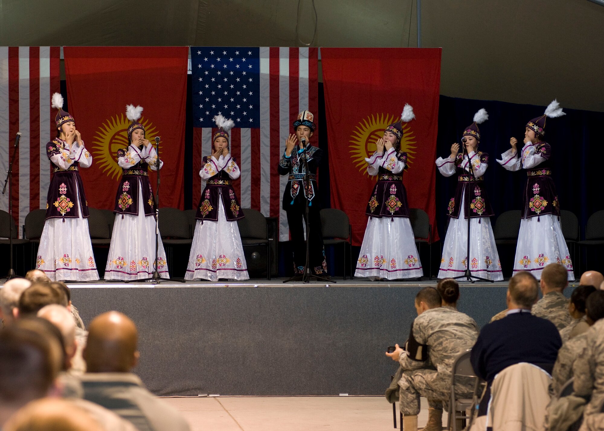 Students from the Mukash Abdraev National School of Music perform at the Transit Center at Manas, Kyrgyzstan, Nov. 27, 2012. Wearing traditional Kyrgyz attire they play a song using mouth harps.  