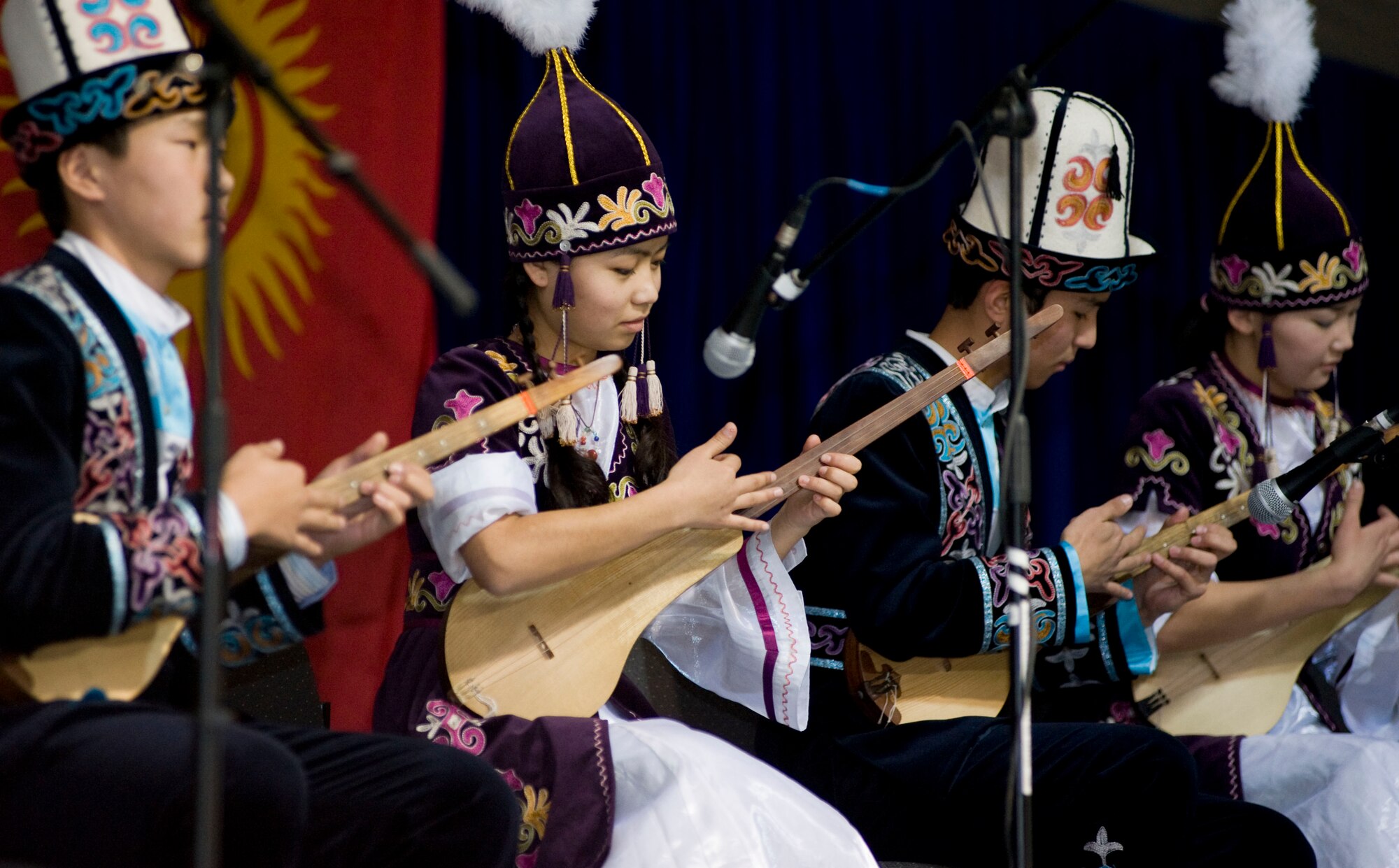 Students from the Mukash Abdraev National School of Music perform at the Transit Center at Manas, Kyrgyzstan, Nov. 27, 2012. Students played performed contempory, classical, and trational Kyrgyz songs. After the concert, they toured the Transit Center, including stops at a KC-135 Stratotanker and 376th Expeditionary Civil Engineer Squadron explosive ordinance disposal team to learn about the installations mission.   