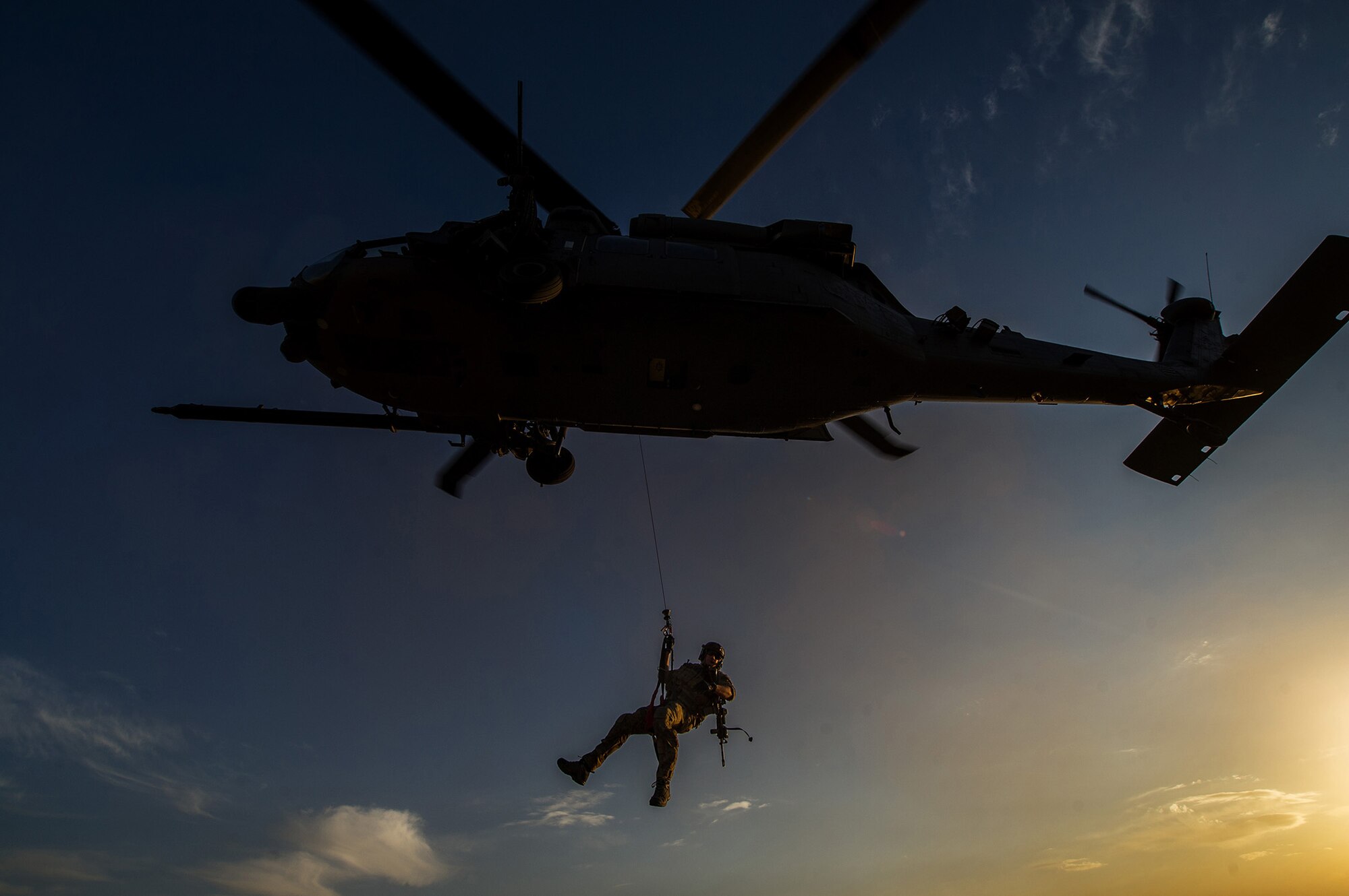 A U.S. Air Force pararescueman is lowered from a U.S. Air Force HH-60 Pave Hawk during a mission Nov. 7, 2012, in Afghanistan. Pararescue teams assault, secure, and dominate the rescue objective area using any available Department of Defense or Allied, air, land, or sea asset. (U.S. Air Force photo/Staff Sgt. Jonathan Snyder)