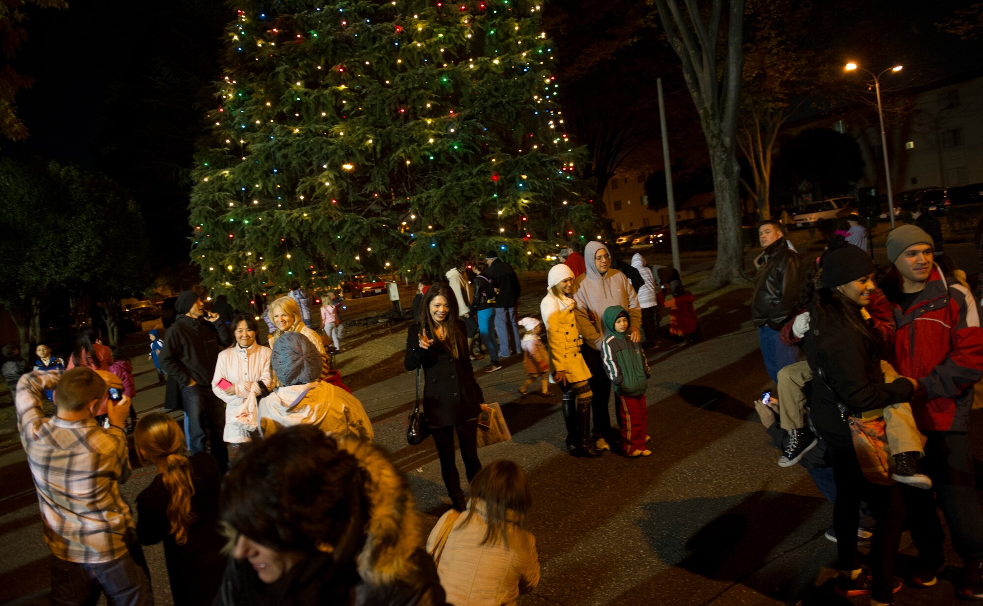 YOKOTA AIR BASE, Japan -- Yokota residents and spectators pose for photographs during the annual tree lighting ceremony at Yokota Air Base, Japan, Nov. 28, 2012. More than 200 spectators attended the annual ceremony starting the holiday season. (U.S. Air Force photo by Senior Airman Andrea Salazar)