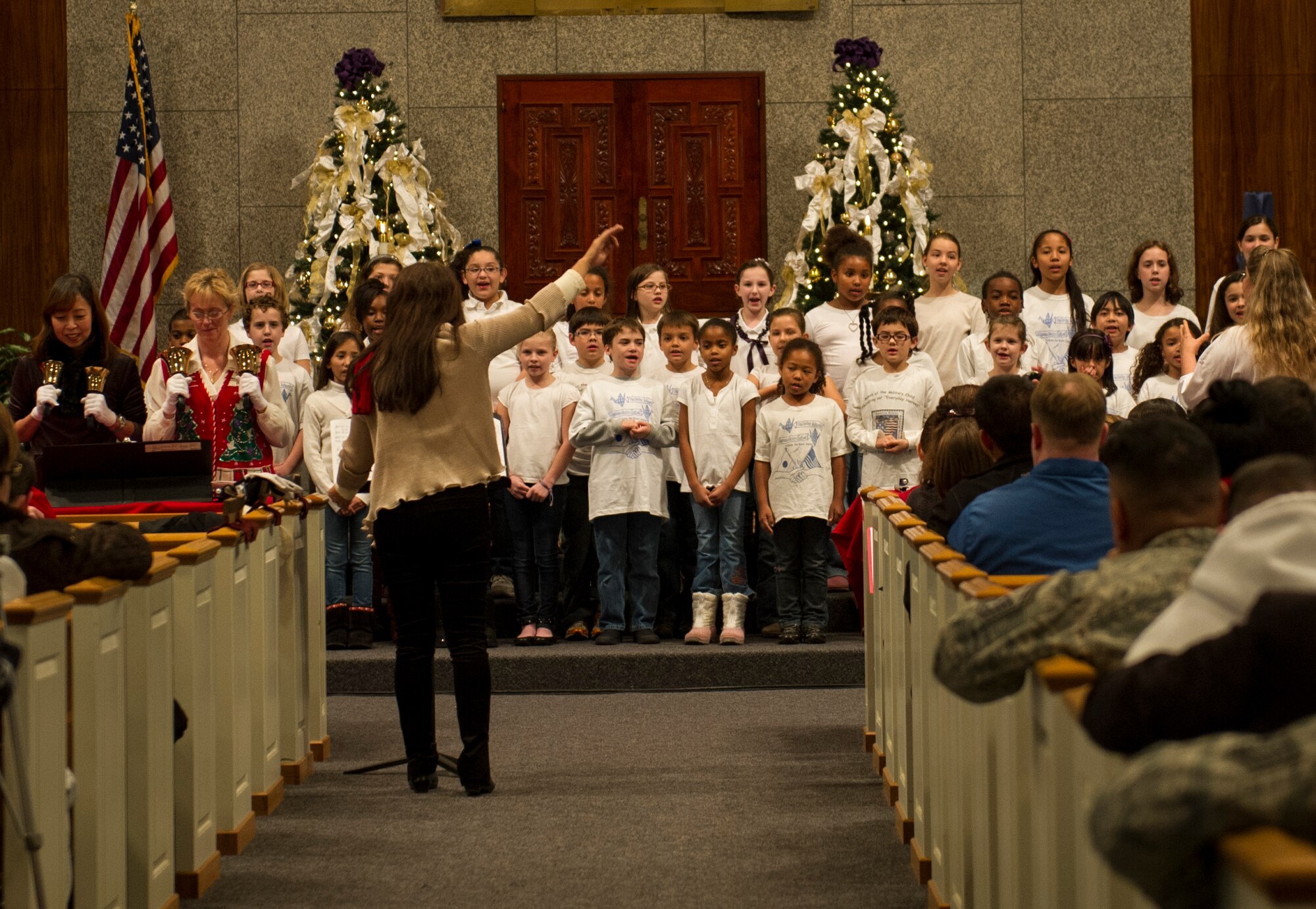 YOKOTA AIR BASE, Japan -- Yokota's Chapel Handbell Choir and Yokota West Elementary School Chorus perform carols prior to the annual tree lighting ceremony Nov. 28, 2012, at Yokota Air Base, Japan. Afterwards, base members were invited to attend holiday festivities at the Taiyo Community Center. (U.S. Air Force photo by Senior Airman Andrea Salazar)