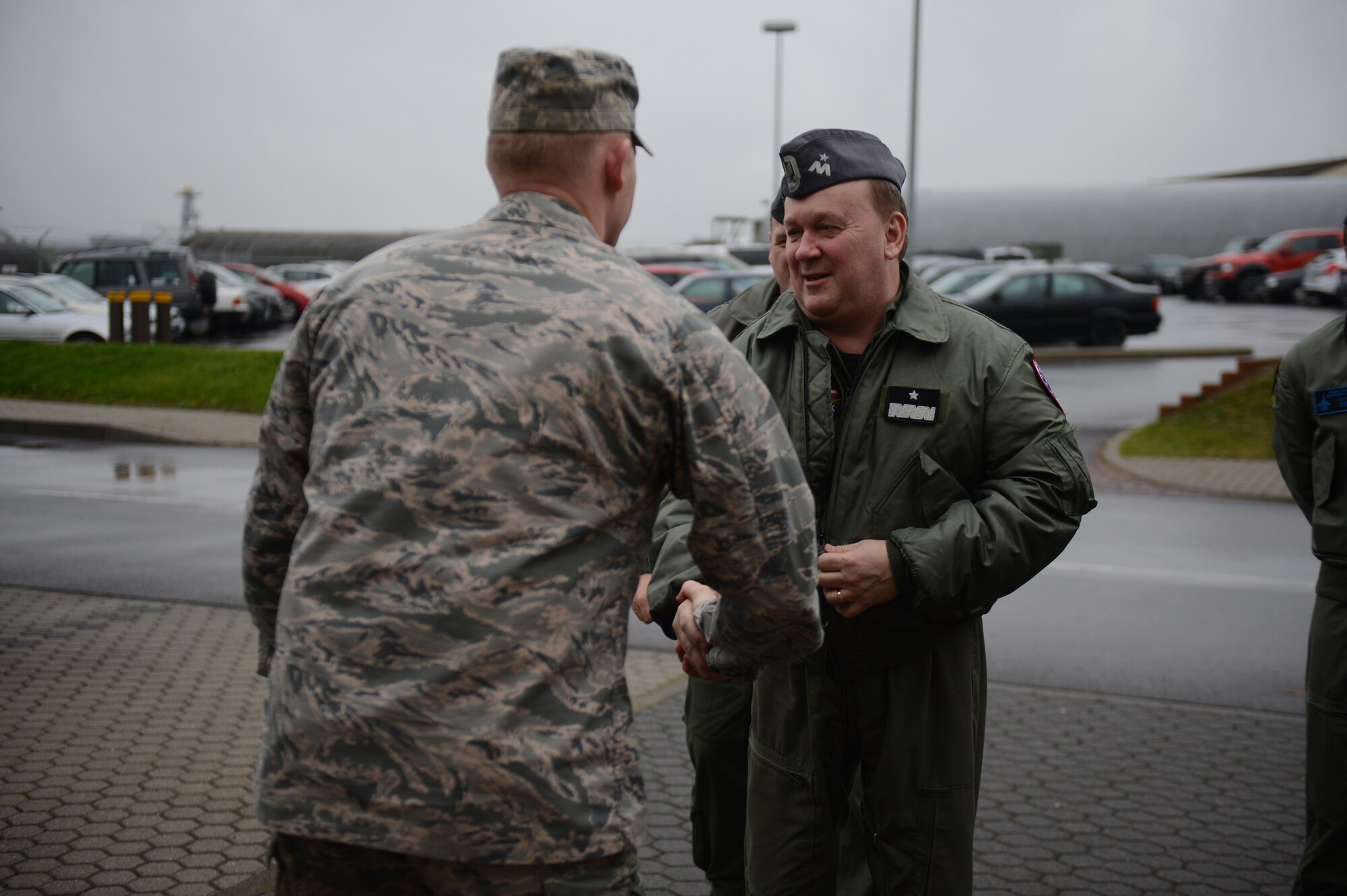 SPANGDAHLEM AIR BASE, Germany – U.S. Air Force Col. Joseph McFall, 52nd Fighter Wing vice commander from Maple Valley, Wash., shakes the hand of Polish air force Brig. Gen. Wlodzimierz Usarek, 2nd Tactical Air Wing commander, near the 480th Fighter Squadron during a visit to Spangdahlem Air Base Nov. 26, 2012.  Usarek, Polish air force leadership and the 52nd Fighter Wing wish to learn from each other and share ideas to better both countries’ flight operations. (U.S. Air Force photo by Airman 1st Class Gustavo Castillo/Released)