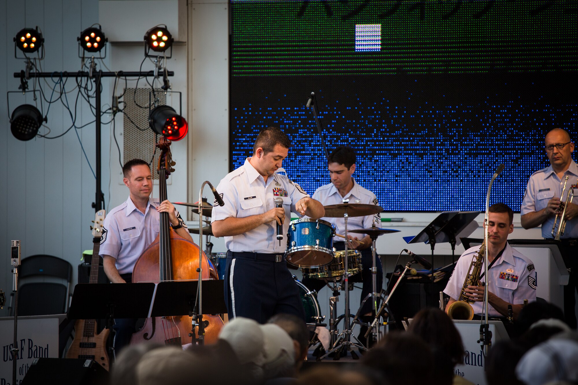 AKISHIMA, Japan -- Tech. Sgt. Justin Allen, Band of the Pacific-Asia vocalist, checks his "watch" on "Ookina Hurodokei," a Japanese rendition of an American folk song, during the lyric "tick-tock" at the Showa-no-Mori Music Festival, Akishima, Japan on Sept. 7, 2012. Allen was a stage actor prior to joining the Air Force and regularly uses his experience to pantomine, adding to his performance. (U.S. Air Force photo/Staff Sgt. Josh Voyles)