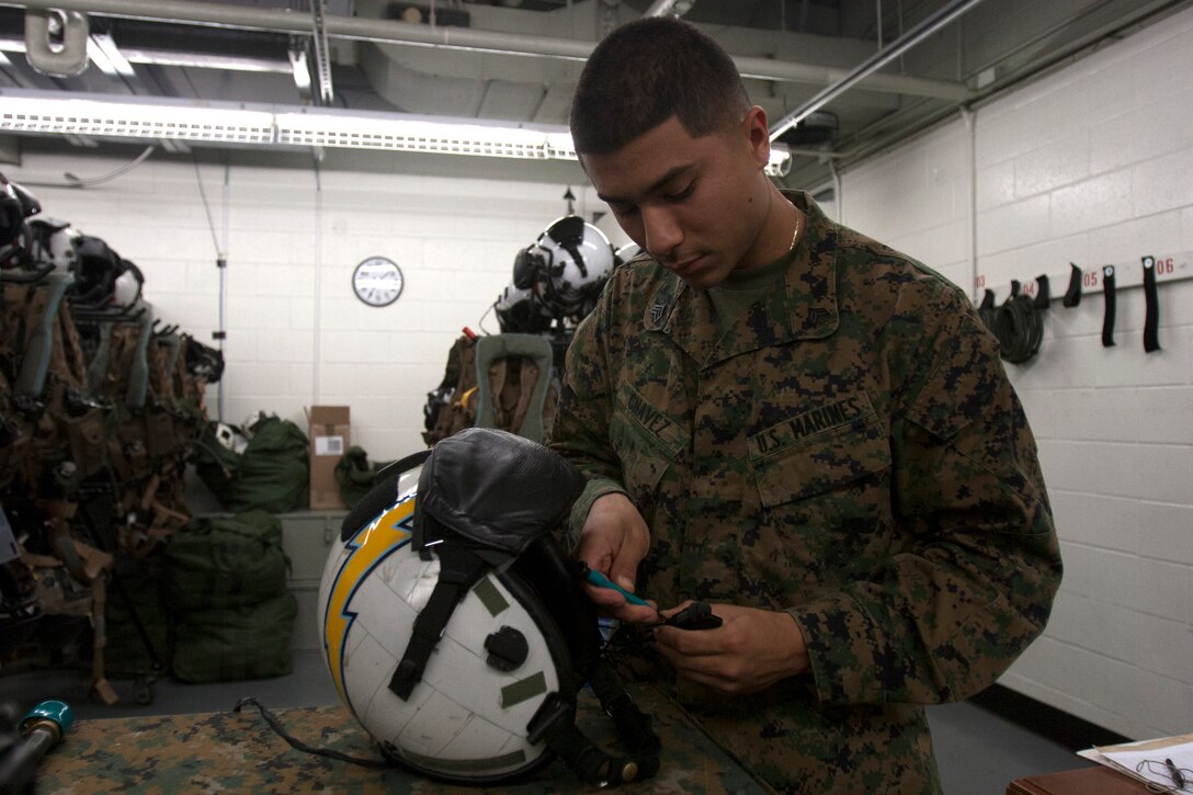 Sgt. Jaime Chavez, a flight equipment technician with Marine Medium Tiltrotor Squadron 363, fixes a microphone on a helmet aboard Marine Corps Air Station Miramar, Calif., Nov. 28. Flight equipment technicians are jacks of all trades. They occasionally perform maintenance on the aircraft, along with maintenance on the squadron’s personnel gear. A big part of flight equipments’ job is sewing.