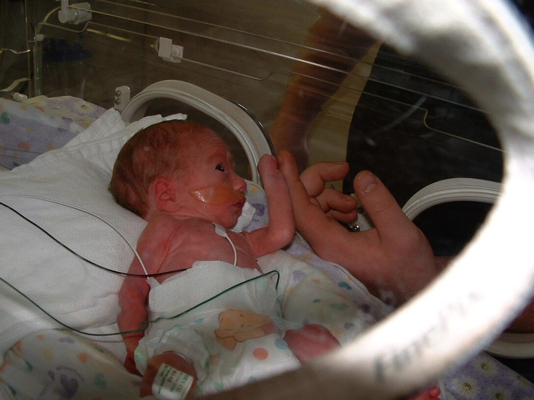 One-day-old Lily Parrish touches her father, Jonathan Parrish’s hand at the neonatal intensive care unit of Jackson-Madison County General Hospital in Jackson, Tenn., March 7, 2009. Lily was born 59 days premature and spent 32 days in neonatal intensive care. Jonathan Parrish has since joined the Marine Corps and is now a lance corporal assigned to Marine Attack Squadron 542 at Cherry Point. The Parrish family serves as the ambassador family for the Crystal Coast March of Dimes March for Babies. The March of Dimes is a national organization that raises funds for research on pregnancy, prematurity and birth defects.