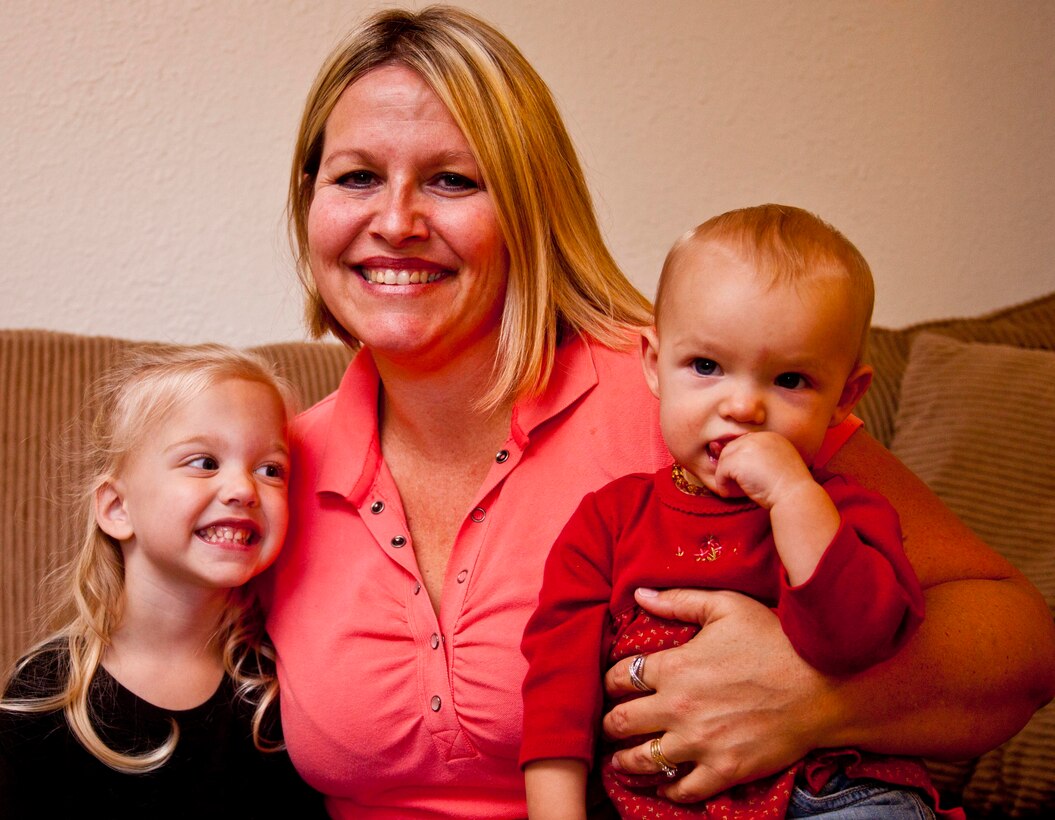 Tiffany Parrish, center, smiles with her two daughters, Lily (left) and Allie, at their home aboard Marine Corps Air Station Cherry Point, N.C., Nov. 26. The Parrish family serves as an ambassador family for the March of Dimes, an organization that that raises funds for research on pregnancy, prematurity and birth defects.