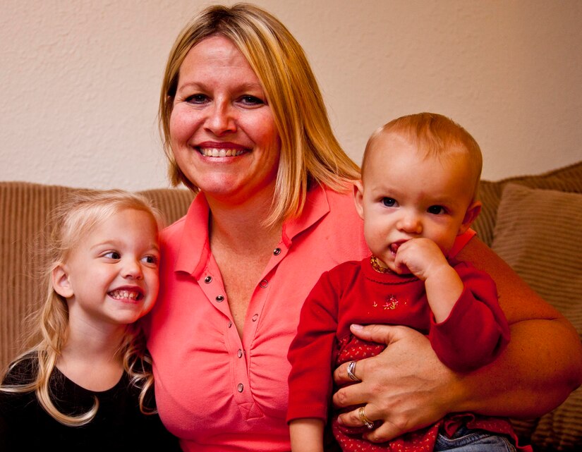 Tiffany Parrish, center, smiles with her two daughters, Lily (left) and Allie, at their home aboard Marine Corps Air Station Cherry Point, N.C., Nov. 26. The Parrish family serves as an ambassador family for the March of Dimes, an organization that that raises funds for research on pregnancy, prematurity and birth defects.