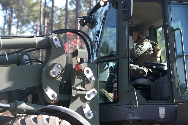 Lance Cpl. Lawrence Hulst, a Marine Wing Support Squadron 273 heavy equipment operator, clears brush on Paige Field, Nov. 19. The work will help the environment and ensure heavy equipment Marines have quality training.