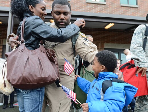 Staff Sgt. Corey Dunn, 10th Airlift Squadron loadmaster, hugs his family prior to his deployment in support of Operation Enduring Freedom, Nov. 29, 2012, at Joint Base Lewis-McChord, Wash. While deployed, Dunn, along with approximately 75 others from the 10th AS, will perform their mission of global strategic airlift, airdrop and aeromedical evacuation in and around Afghanistan, Iraq and the Horn of Africa. (U.S. Air Force/Staff Sgt. Sean Tobin)