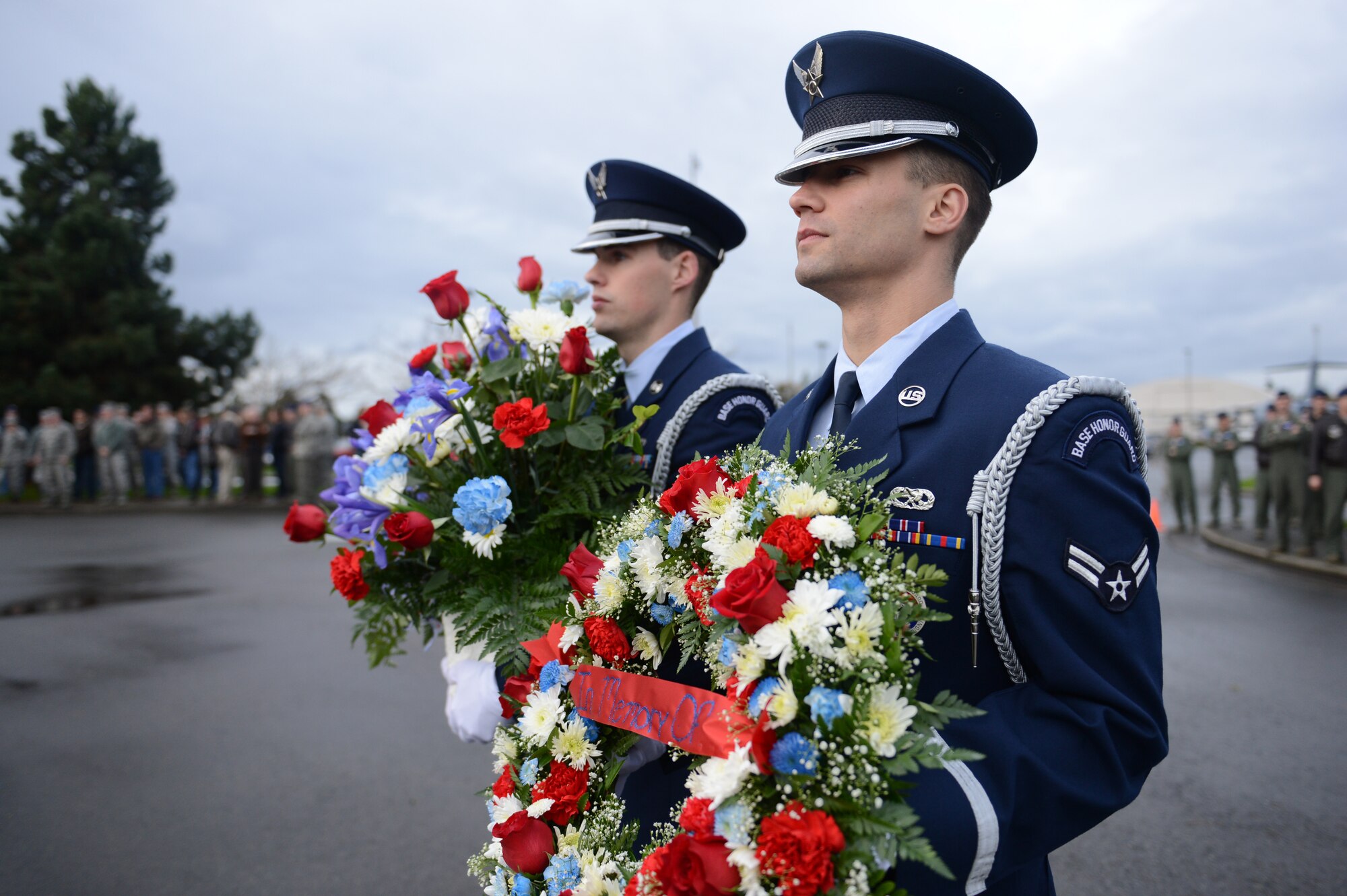 Airman 1st Class Karl Zaleski (right), McChord Field Honor Guard member, carries a wreath while Senior Airman Christopher Allen (left), McChord Field Honor Guard member, carries flowers during a memorial ceremony Nov. 30, 2012 at Joint Base Lewis-McChord, Wash., to commemorate the 20th anniversary of when two C-141 Starlifter aircraft collided over north-central Montana. The wreath and flowers were placed in front of the C-141 memorial site located in between the 4th and 8th Airlift Squadron buildings on McChord Field. (U.S. Air Force photo/Staff Sgt. Frances Kriss)