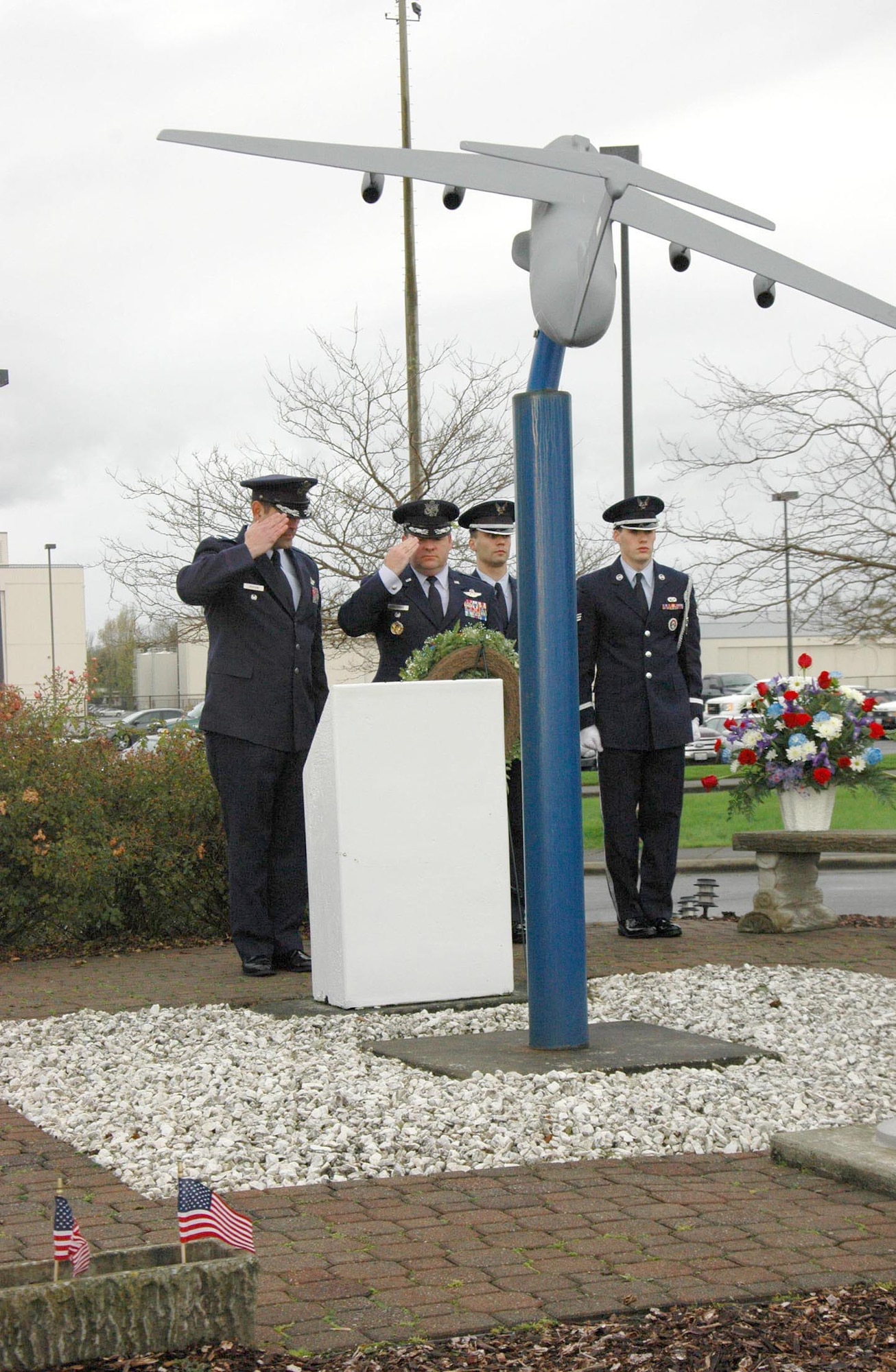 Col. Rick Grayson, 446th Airlift Wing vice commander, (left) and Col. Jeffrey Philippart, 62nd AW vice commander, render salutes Nov. 30, in remembrance of 13 aviators who died 20 years ago this day in 1992. The 13 McChord Airmen were killed when two C-141s from McChord Air Force Base, Wash., collided over Montana during an air refueling training mission. (U.S. Air Force photo by Sandra Pishner)