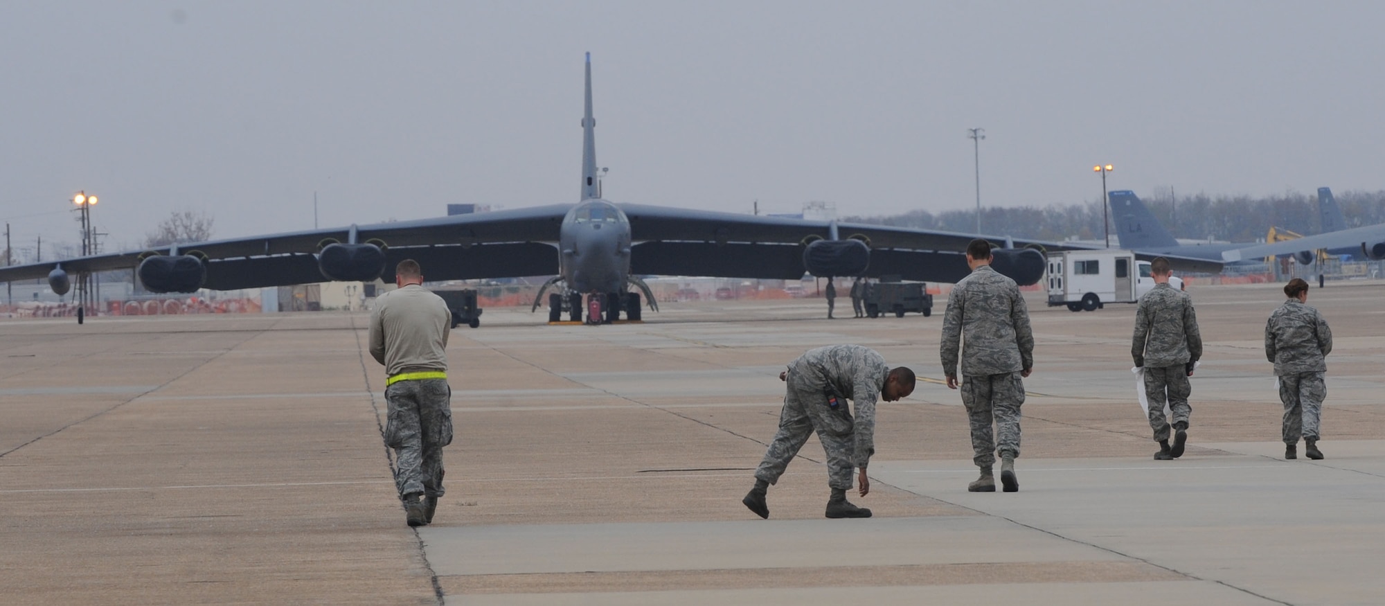 Airmen from 2nd Aircraft Maintenance Squadron conduct a foreign object debris walk on the flightline at Barksdale Air Force Base, La., Nov. 30. FOD walks are performed to ensure items such as trash and rocks are not left on the flightline to prevent damage to jet engines. (U.S. Air Force photo/Senior Airman Kristin High)