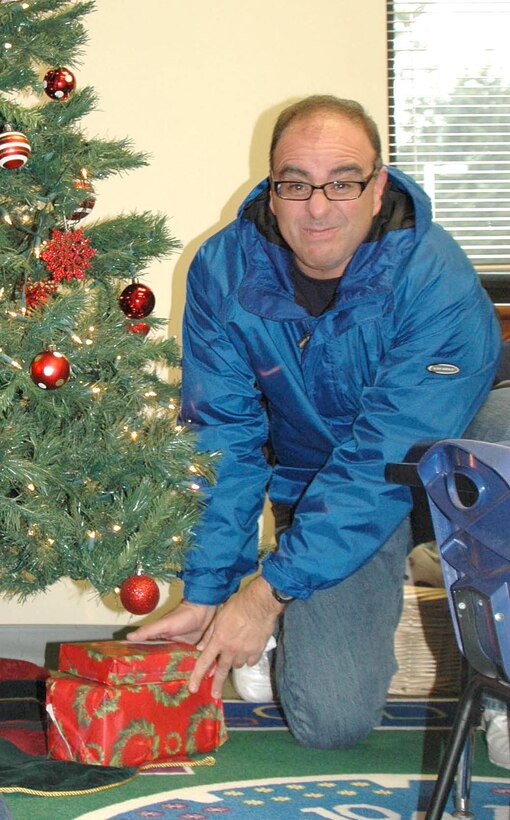 Tech. Sgt. John Lewis, 446th Maintenance Operations Flight, McChord Field, Wash., drops off some gifts for an 8-year-old boy whose name he plucked off the Reserve's Angel Tree.  The Angle Tree is located in the 446th Force Support Squadron's Airman and Family Readiness Center in Bldg. 1207. (U.S. Air Force photo by Sandra Pishner)
