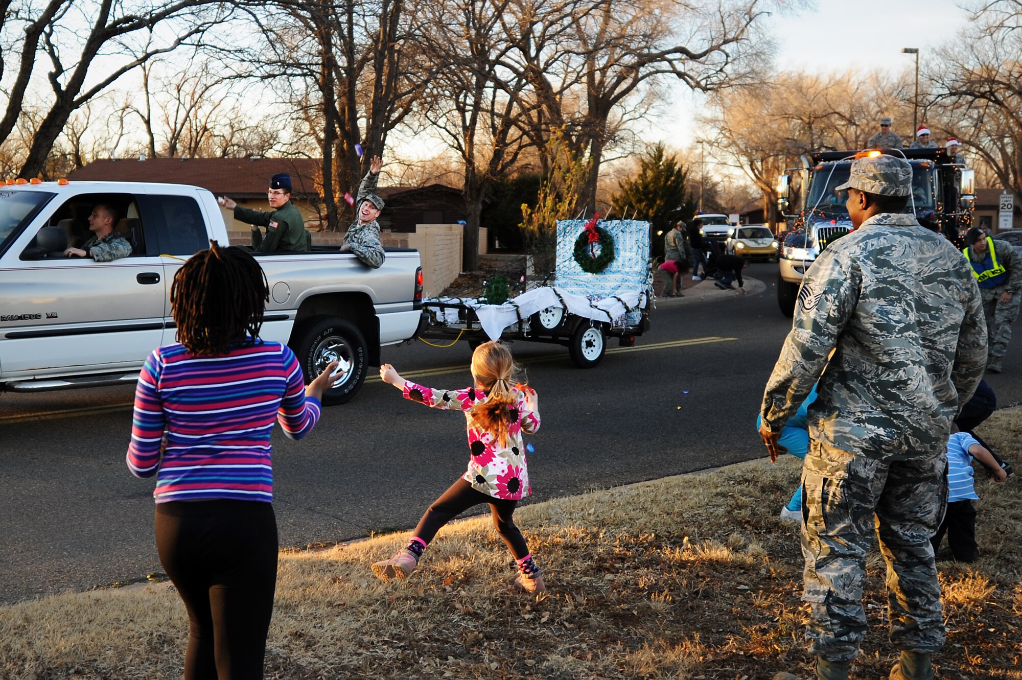 Children run for candy as a float passes during the annual holiday parade and tree lighting ceremony at Cannon Air Force Base, N.M., Nov. 29, 2012.  This festive event takes place each year as a kick-off to the holiday season.  (U.S. Air Force photo/Senior Airman Jette Carr)