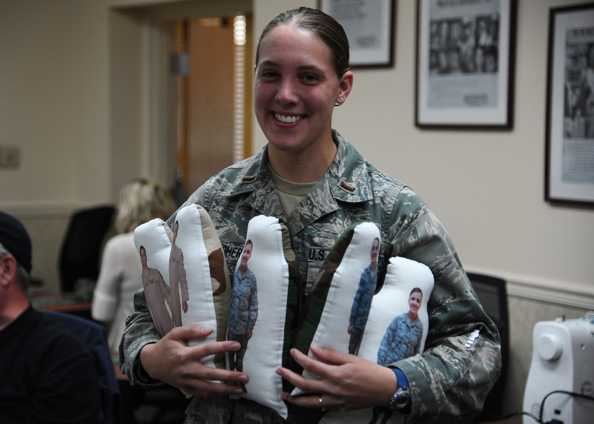 Second Lt. Courtney Gallagher holds several Huggable Uniform Gifts made by volunteers at the Columbus Air Force Base Airman and Family Readiness Center.  Columbus AFB is the first base to offer these dolls free of charge to family members of deployed Airmen.  (U.S. Air Force Photo/Airman 1st Class Charles Dickens)