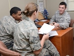 Airman 1st Class Keri Odum, David Corbett and Kevin Failla 902nd Comptroller Squadron finance technicians, discuss proper payroll procedures for incoming Airmen Nov. 28 at Joint Base San Antonio-Randolph. (U.S. Air Force photo by Benjamin Faske)