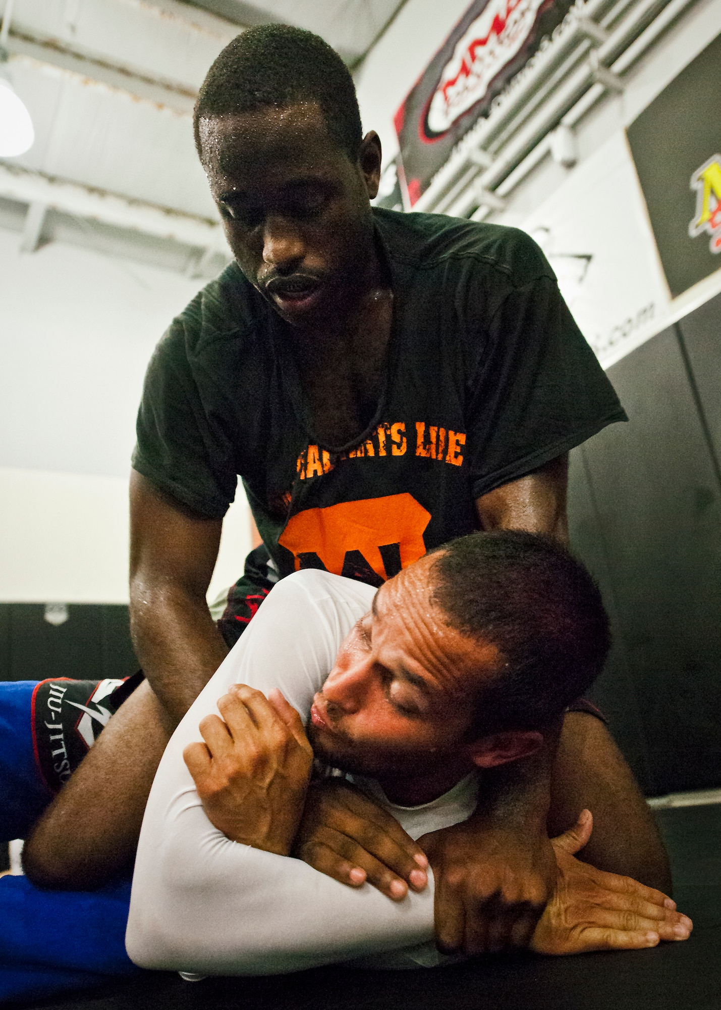 Staff Sgt. Steve Burks, an avionics Airman with the 1st Special Operations Aircraft Maintenance Squadron, works on wrestling drills with his trainer, Daniel Silva, Oct. 26 at a gym in Fort Walton Beach, Fla.  Burks is one of two Air Force fighters fighting at Strike Fight, Eglin Air Force Base's first-ever mixed martial arts event Dec. 8.  Burks enters the fight undefeated with 10 amateur wins and one professional victory. (U.S. Air Force photo/Samuel King Jr.)