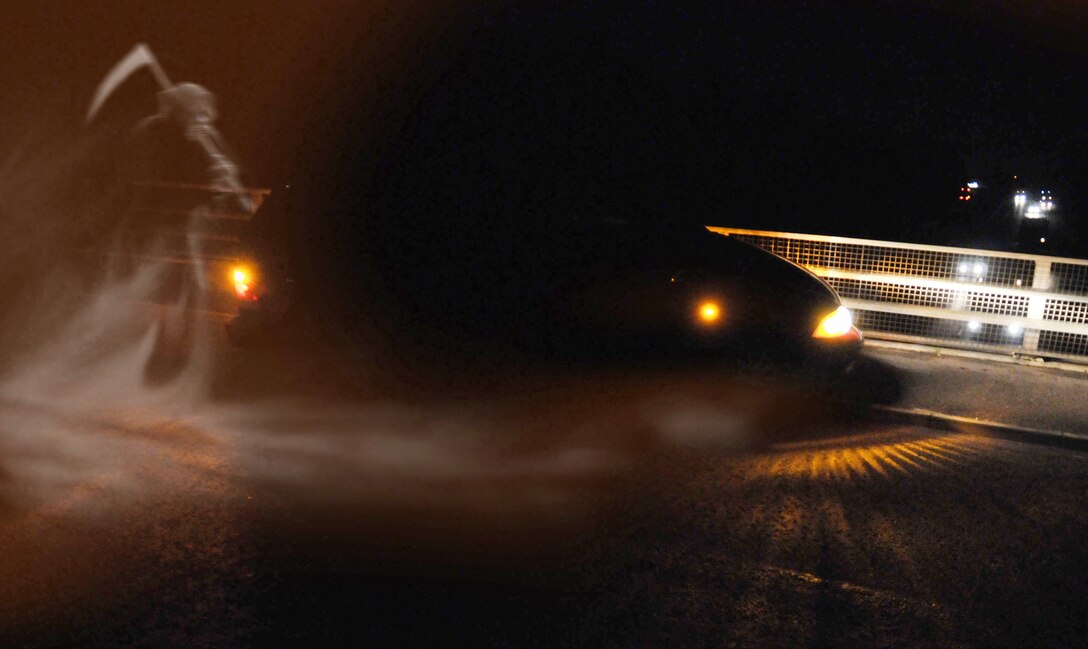 MOUNTAIN HOME AIR FORCE BASE, Idaho - 'Death' creeps up on a families mini-van as they drive along an overpass. Safe winter driving is paramount to keeping Airmen and their loved ones safe. (U.S. Air Force photo illustration/Master Sgt. Kevin Wallace and Chris Ingersol/RELEASED)