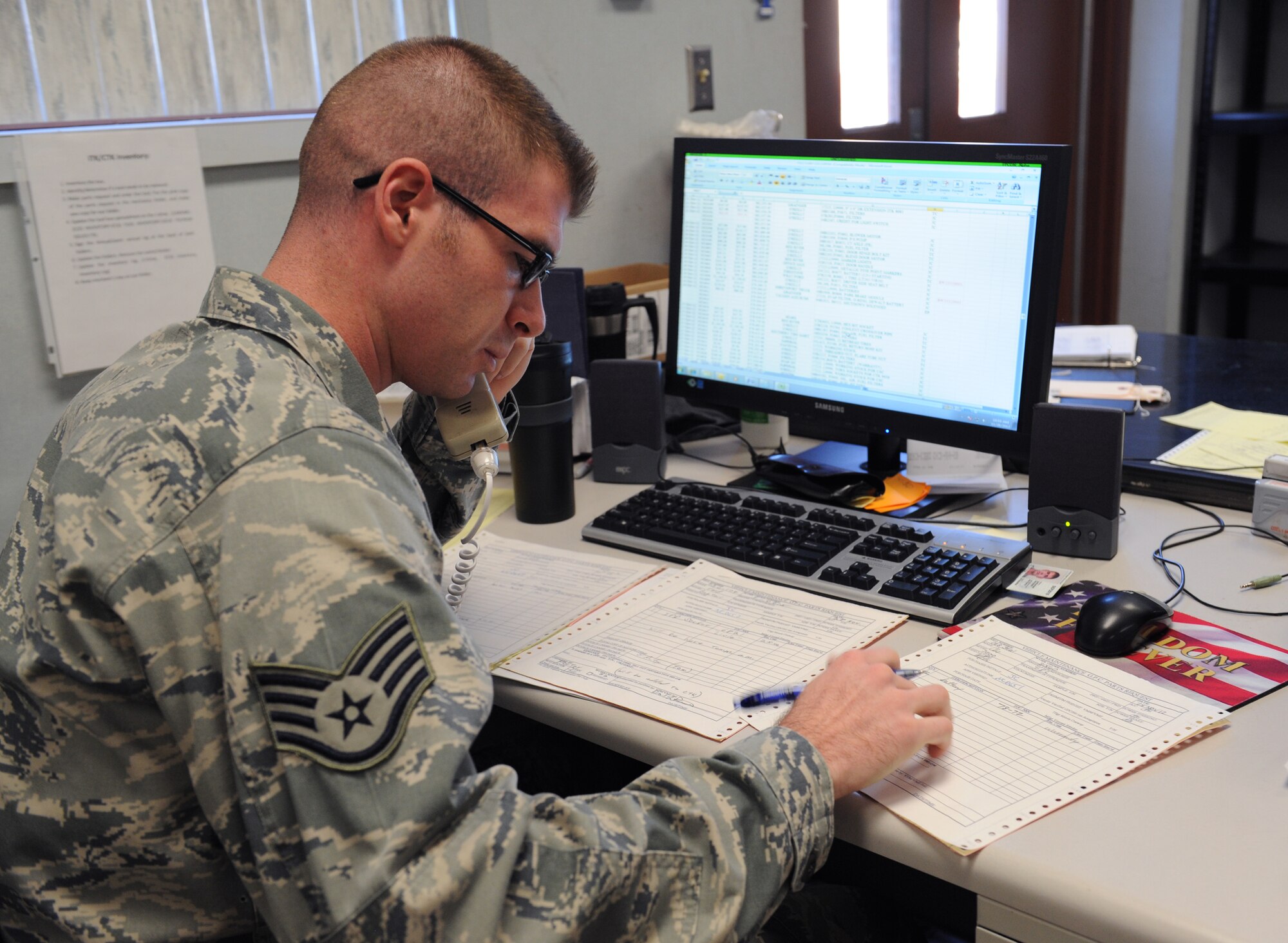 Staff Sgt. Jared Clutter, 2nd Logistics Readiness Squadron Vehicle Maintenance Flight materiel control journeyman, talks to a vendor about acquiring a part on Barksdale Air Force Base, La., Nov. 28. The materiel control section handles the ordering of all equipment and office supplies for the vehicle maintenance flight. (U.S. Air Force photo/Airman 1st Class Benjamin Gonsier)