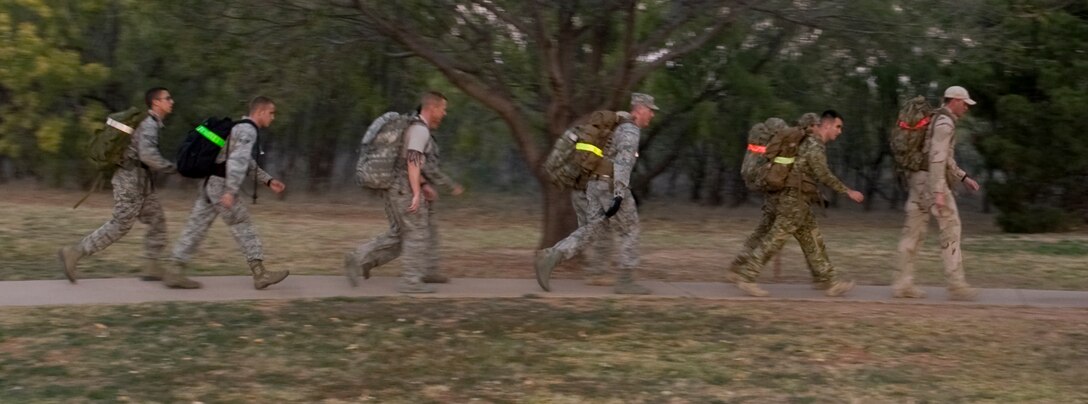 Airmen from the 7th Civil Engineer Squadron's Explosive Ordnance Disposal unit lead a four-mile ruck march Nov. 29, 2012, at Dyess Air Force Base, Texas. The ruck march raised esprit de corps and awareness for the sacrifices made by Air Force EOD technicians throughout the last decade. Members from the EOD flight carried dog tags with the names of 20 Air Force EOD technicians who have been killed in action. (U.S. Air Force photo by Airman 1st Class Peter Thompson/ Released)