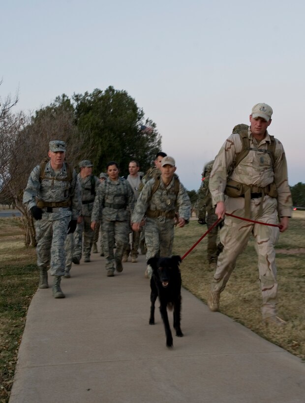 Airmen from the 7th Civil Engineer Squadron's Explosive Ordnance Disposal unit lead a four-mile ruck march Nov. 29, 2012, at Dyess Air Force Base, Texas. The ruck march raised esprit de corps and awareness for the sacrifices made by Air Force EOD technicians throughout the last decade. Members from the EOD flight carried dog tags with the names of 20 Air Force EOD technicians who have been killed in action. (U.S. Air Force photo by Airman 1st Class Peter Thompson/ Released)