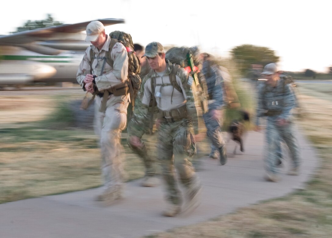 Airmen from the 7th Civil Engineer Squadron's Explosive Ordnance Disposal unit lead a four-mile ruck march Nov. 29, 2012, at Dyess Air Force Base, Texas. The ruck march raised esprit de corps and awareness for the sacrifices made by Air Force EOD technicians throughout the last decade. Members from the EOD flight carried dog tags with the names of 20 Air Force EOD technicians who have been killed in action. (U.S. Air Force photo by Airman 1st Class Peter Thompson/ Released)