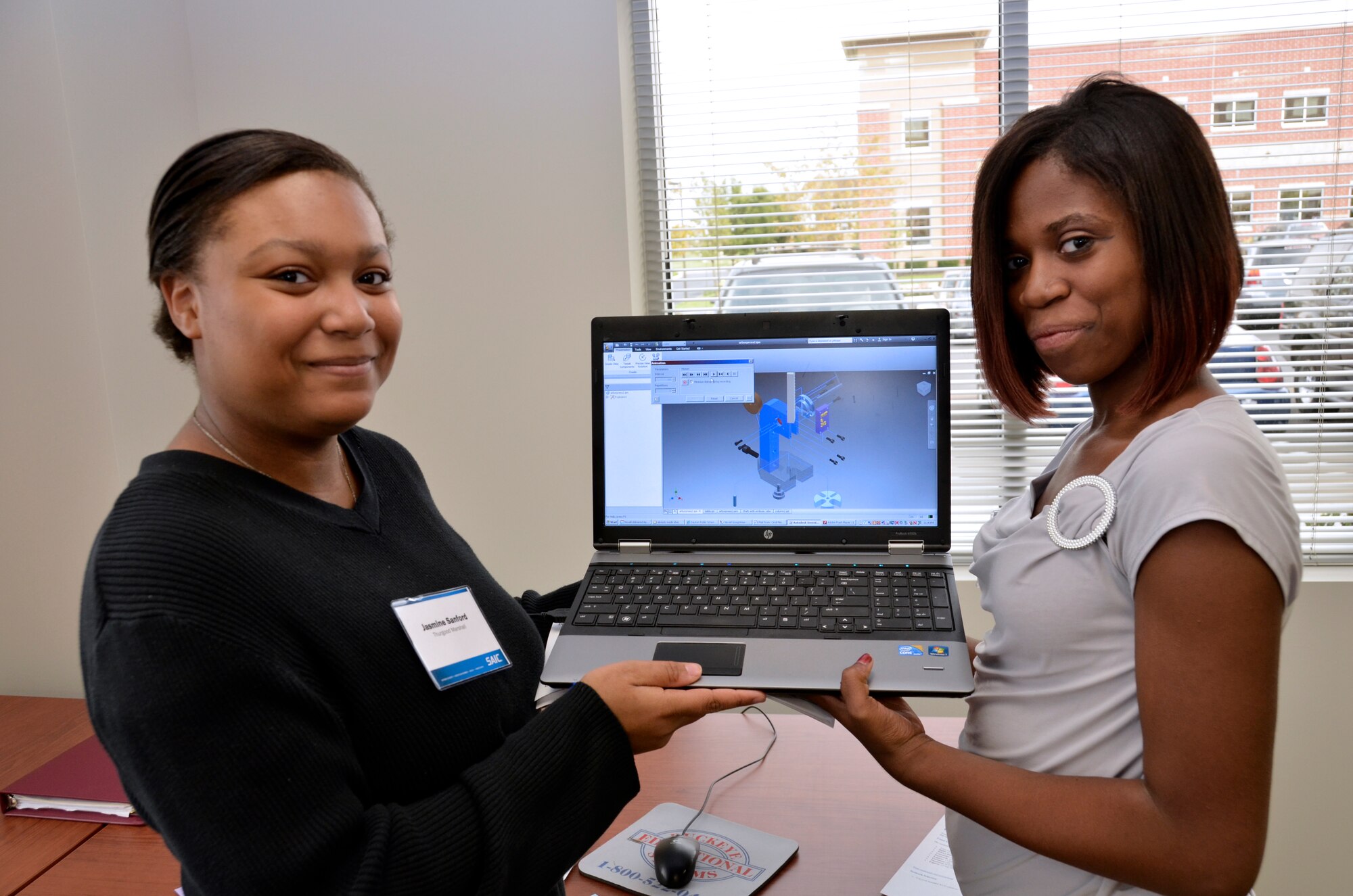 Students Jasmine Sanford and Kadijah Taylor from Thurgood Marshall High School present their project ath the Dayton Regional M&S Competition in September 2012.   (Photo by Mikee Huber)