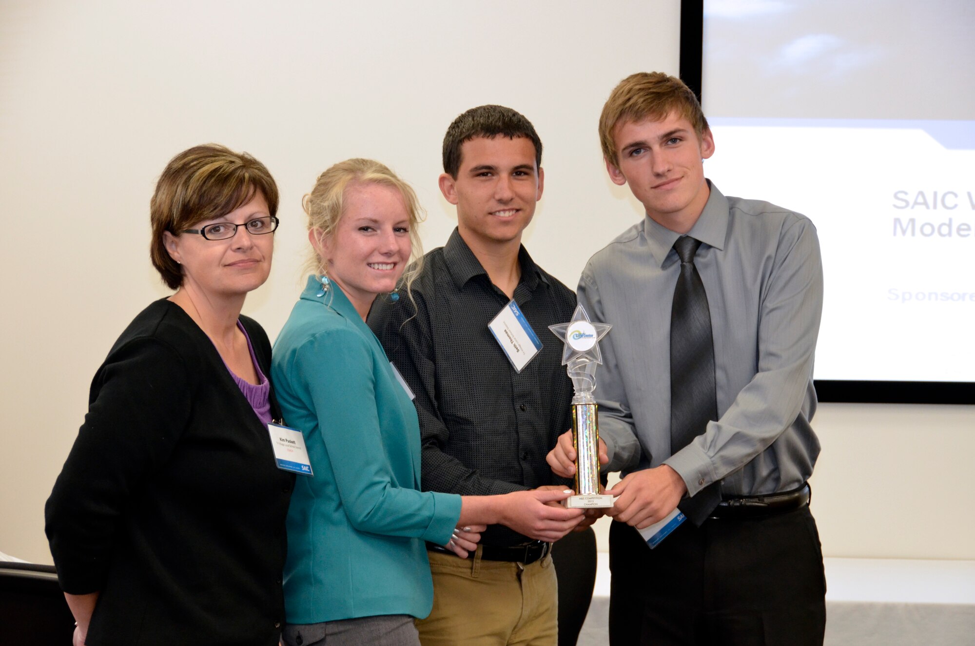 Tri-Village High School teacher, Ms. Kim Puckett, stands with her students and the Dayton Regional M&S Competition winners Macy Fraylick, Seth Thomas, and Craig Harrison.  The students will present their project at the I/ITSEC Conference in Florida in December.  (Photo by Mikee Huber)