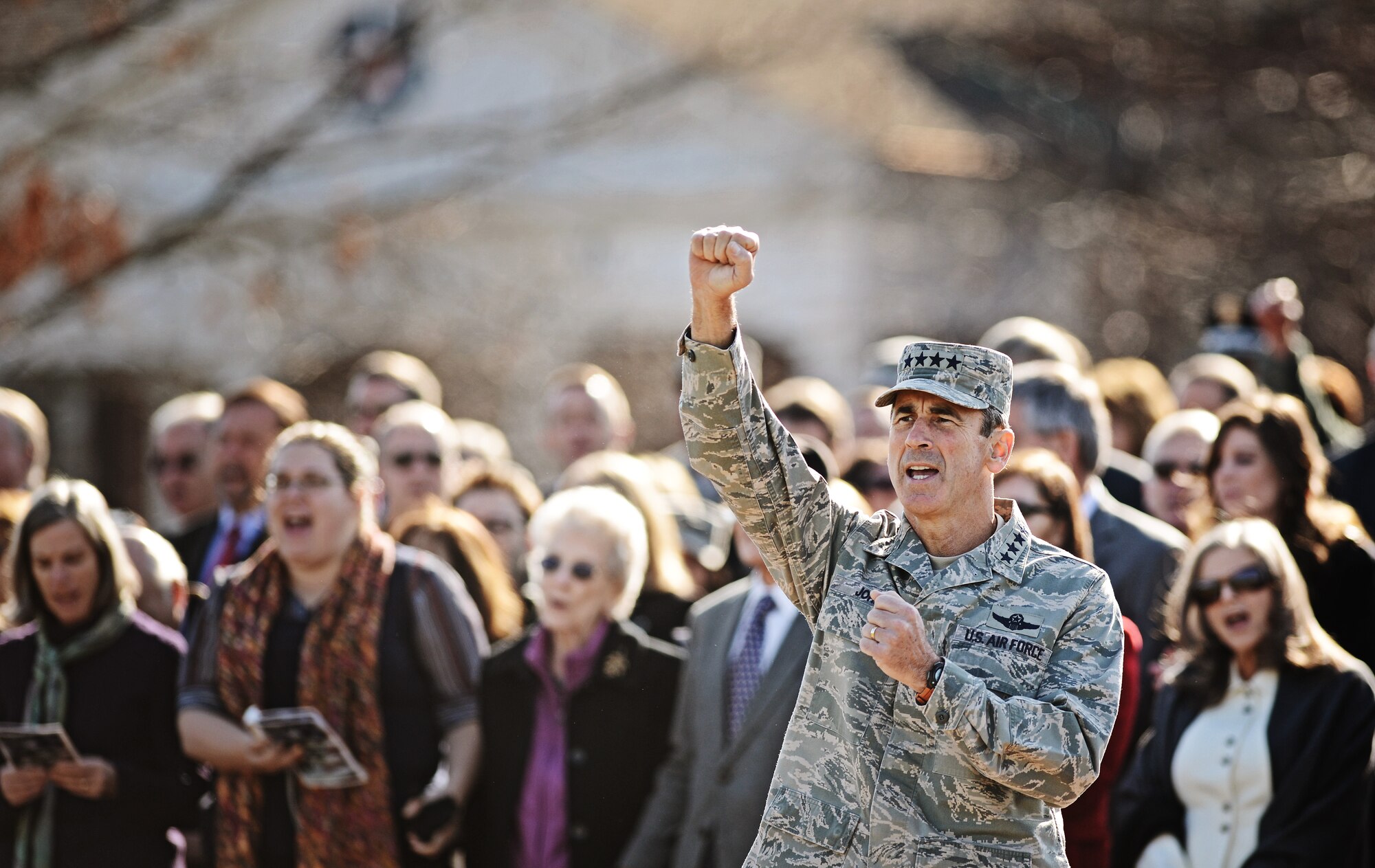 Gen. Raymond E. Johns Jr., Air Mobility Command commander, cheers as he sings along with the Air Force song during the Air Mobility Command change of command ceremony at Scott Air Force Base Nov. 30, 2012. Johns served 35 years in the Air Force, commanding more than 130,000 Airmen as well as reaching 4,500 flight hours in various aircraft. The incoming AMC commander, Gen. Paul J. Selva, was previously assigned as the assistant to the Chairman of the Joint Chiefs of Staff in Washington D.C. (U.S. Air Force photo/ Staff Sgt. Ryan Crane)
