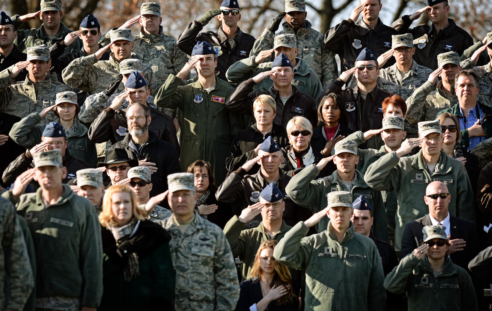Airmen and civilians render a salute as the national anthem plays during the Air Mobility Command change of command ceremony at Scott Air Force Base, Nov. 30, 2012. Gen. Mark A. Welsh III presided over the transition from Gen. Raymond E. Johns Jr. to Gen. Paul J Selva. Johns served 35 years in the Air Force, commanding more than 130,000 Airmen as well as reaching 4,500 flight hours in various aircraft. The incoming AMC commander, Selva, was previously assigned as the assistant to the Chairman of the Joint Chiefs of Staff in Washington D.C. (U.S. Air Force photo/ Staff Sgt. Ryan Crane)