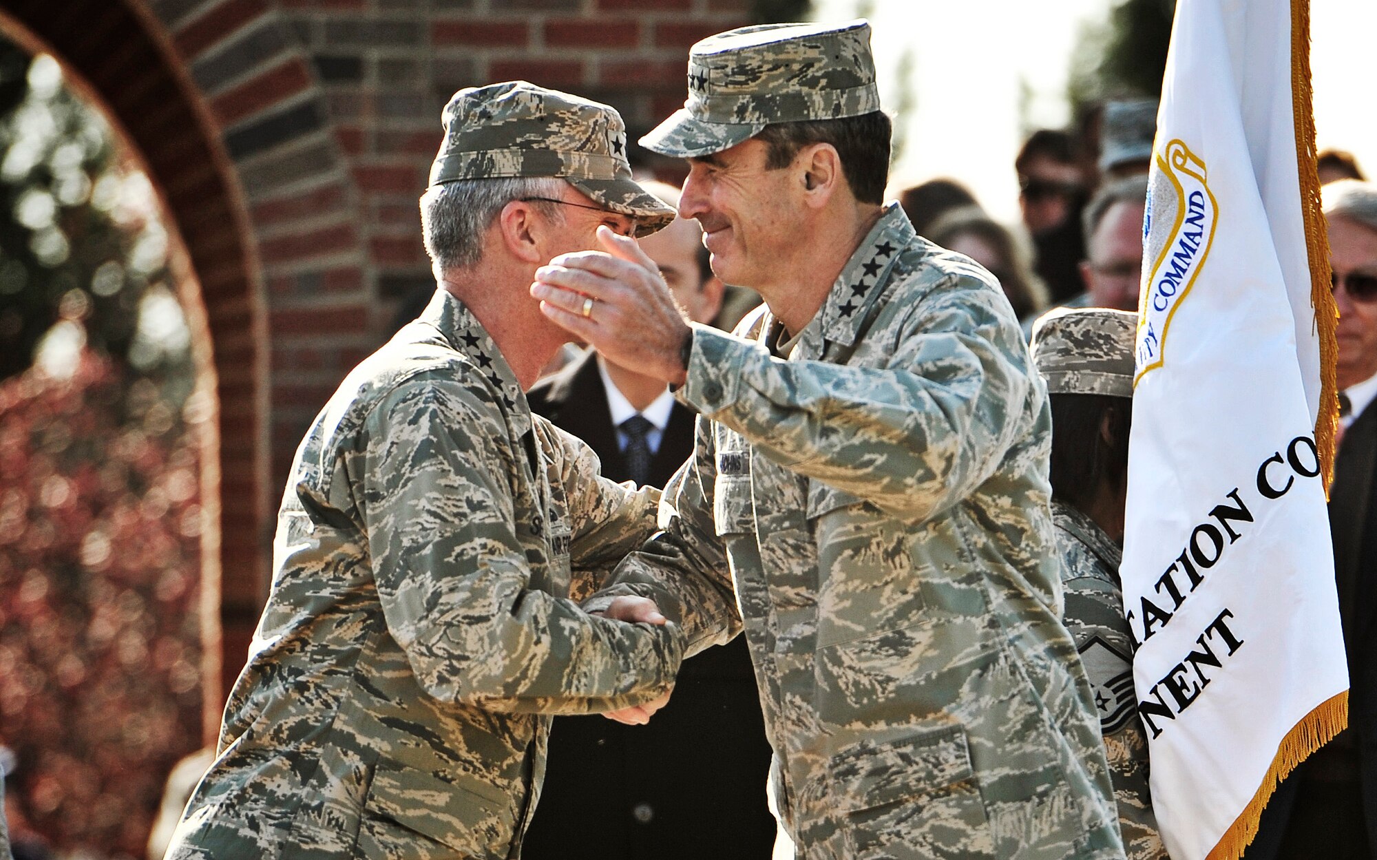 Gen. Raymond E. Johns Jr. congratulates Gen. Paul J. Selva, the new Air Mobility Command commander, after the AMC change of command ceremony at Scott Air Force Base, Nov. 30, 2012. Johns served 35 years in the Air Force, commanding more than 130,000 Airmen as well as reaching 4,500 flight hours in various aircraft. Selva was previously assigned as the assistant to the Chairman of the Joint Chiefs of Staff in Washington D.C. (U.S. Air Force photo/ Staff Sgt. Ryan Crane)