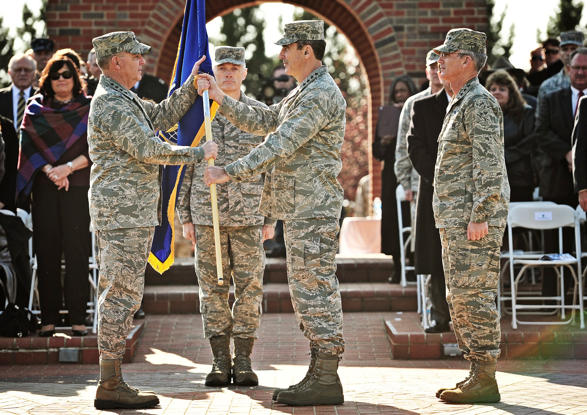 Gen. Raymond E. Johns Jr., Air Mobility Command commander, relinquishes the guidon to Gen. Mark A. Welsh III, Air Force Chief of Staff, during the AMC change of command ceremony at Scott Air Force Base, Nov. 30, 2012. Johns served 35 years in the Air Force, commanding more than 130,000 Airmen as well as reaching 4,500 flight hours in various aircraft. The incoming AMC commander, Gen. Paul J. Selva, was previously assigned as the assistant to the Chairman of the Joint Chiefs of Staff in Washington D.C. (U.S. Air Force photo/ Staff Sgt. Ryan Crane)
