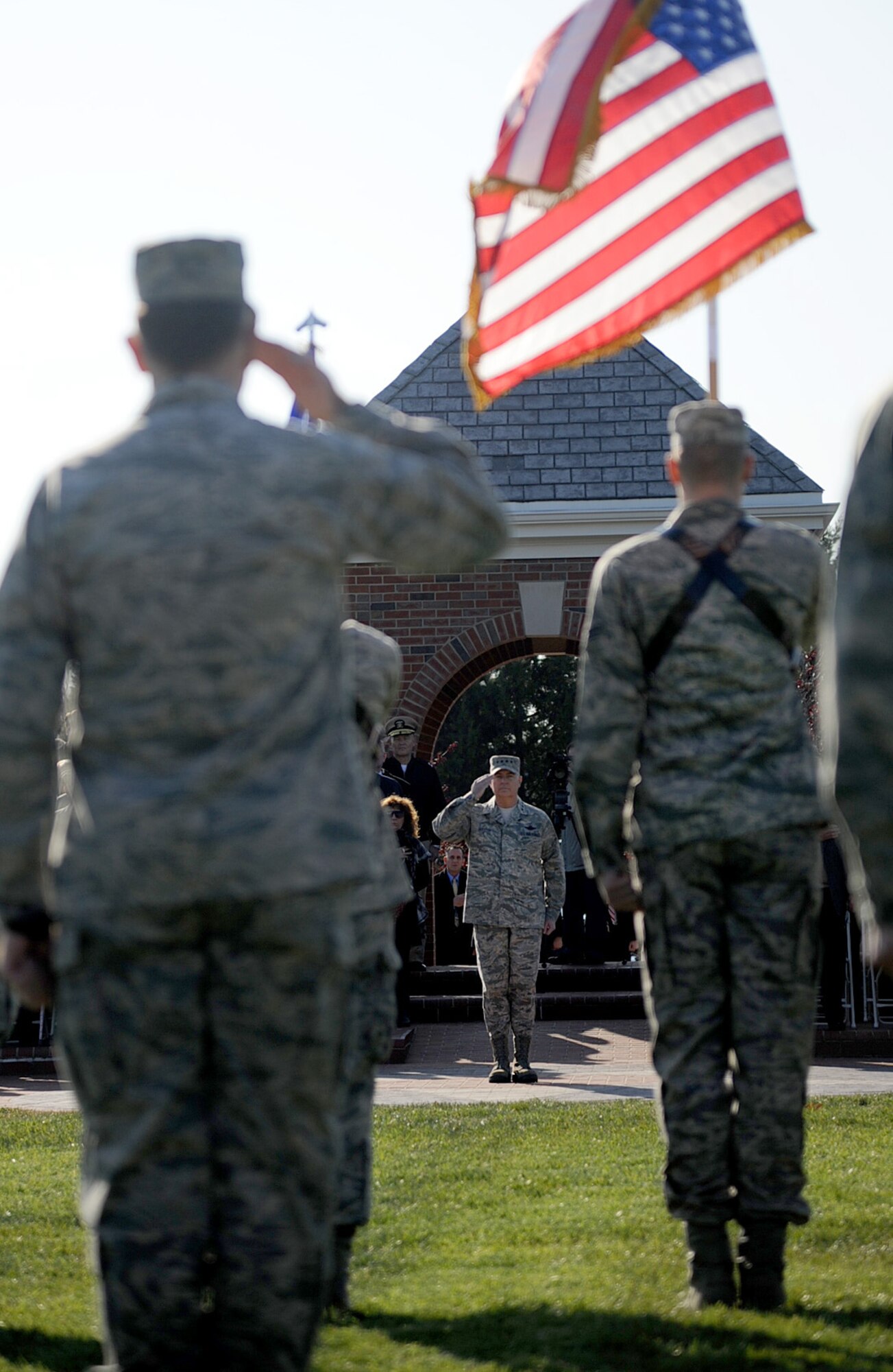 Members of Scott Air Force render a salute during at the Air Mobility Command change of command ceremony during the change of command ceremony at Scott Air Force Base Nov. 30, 2012. The outgoing commander, Gen. Raymond E. Johns Jr. served 35 years in the Air Force, commanding more than 130,000 Airmen as well as reaching 4,500 flight hours in various aircraft. (U.S. Air Force photo/ Senior Airman Tristin English)