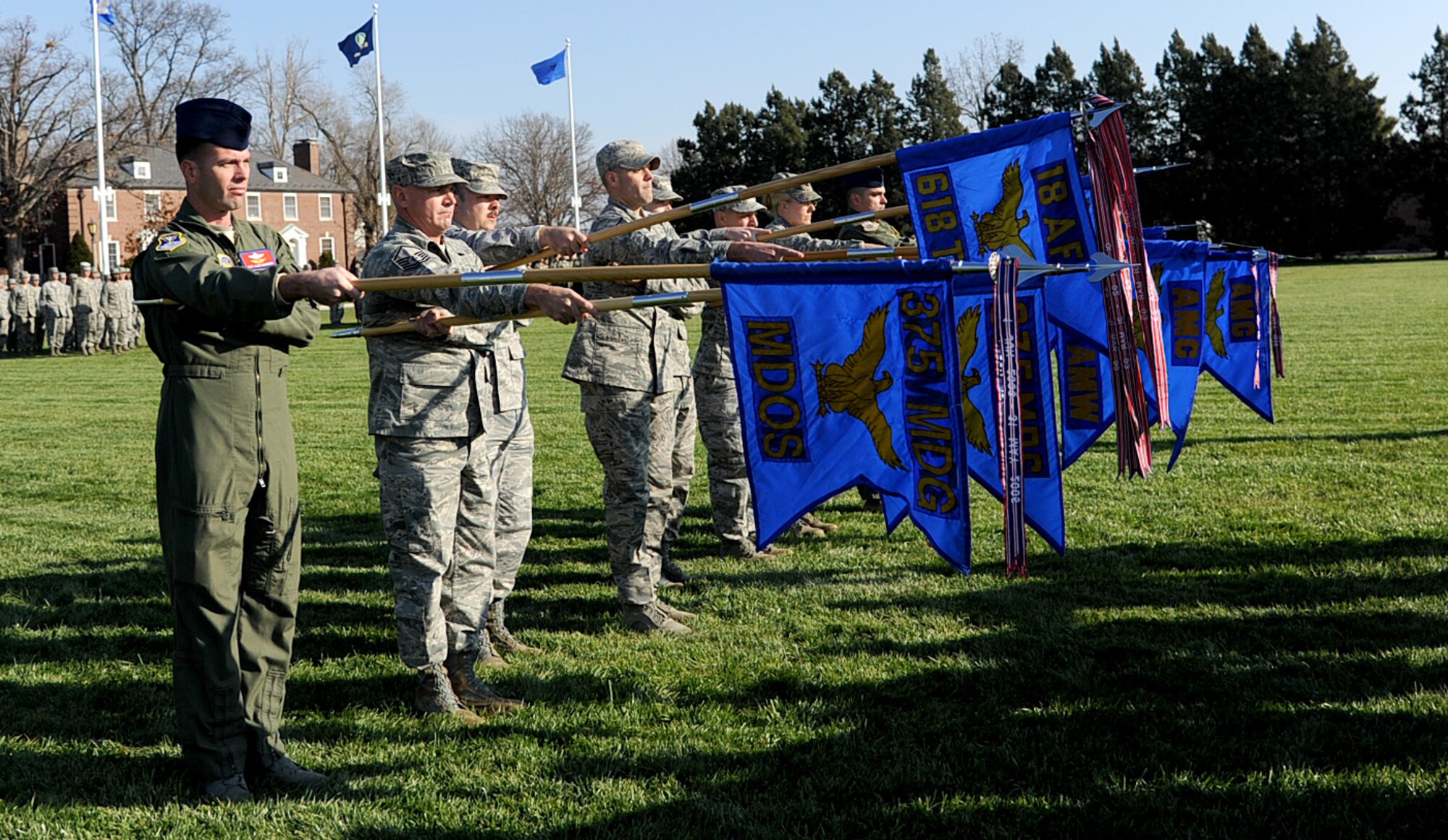 Members  of Scott Air Force base present their guidon at the Air Mobility Command change of command ceremony during the change of command ceremony at Scott Air Force Base Nov. 30, 2012. The outgoing commander, Gen. Raymond E. Johns Jr. served 35 years in the Air Force, commanding more than 130,000 Airmen as well as reaching 4,500 flight hours in various aircraft. (U.S. Air Force photo/ Senior Airman Tristin English)